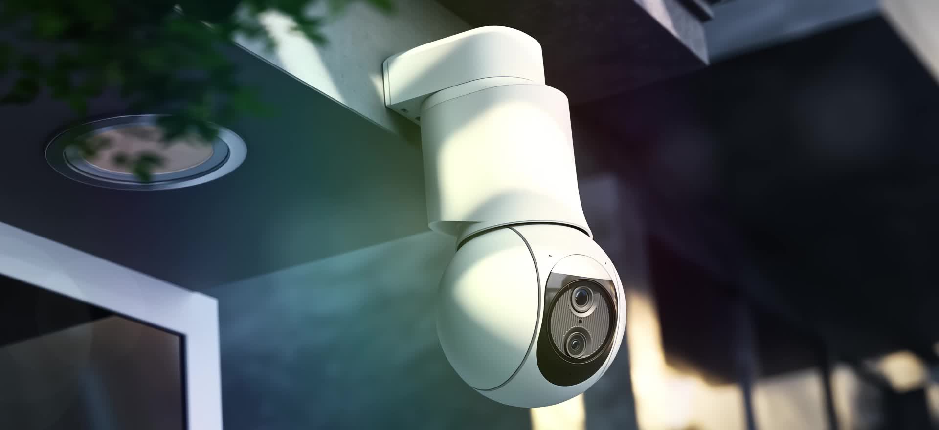 three white CCTV cameras mounted on wall