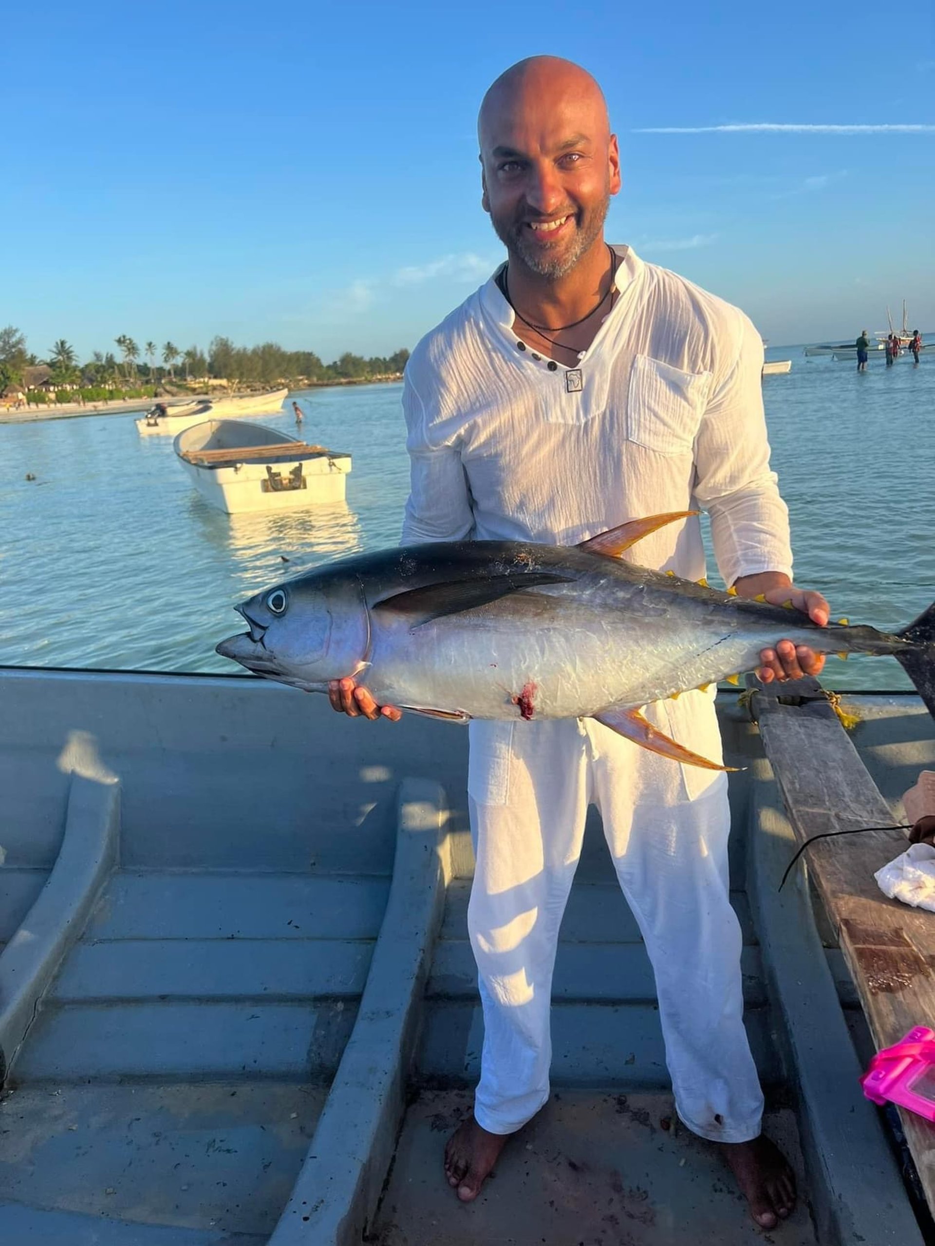 Catamaran Seychelles happy man with Yellowfin Tuna