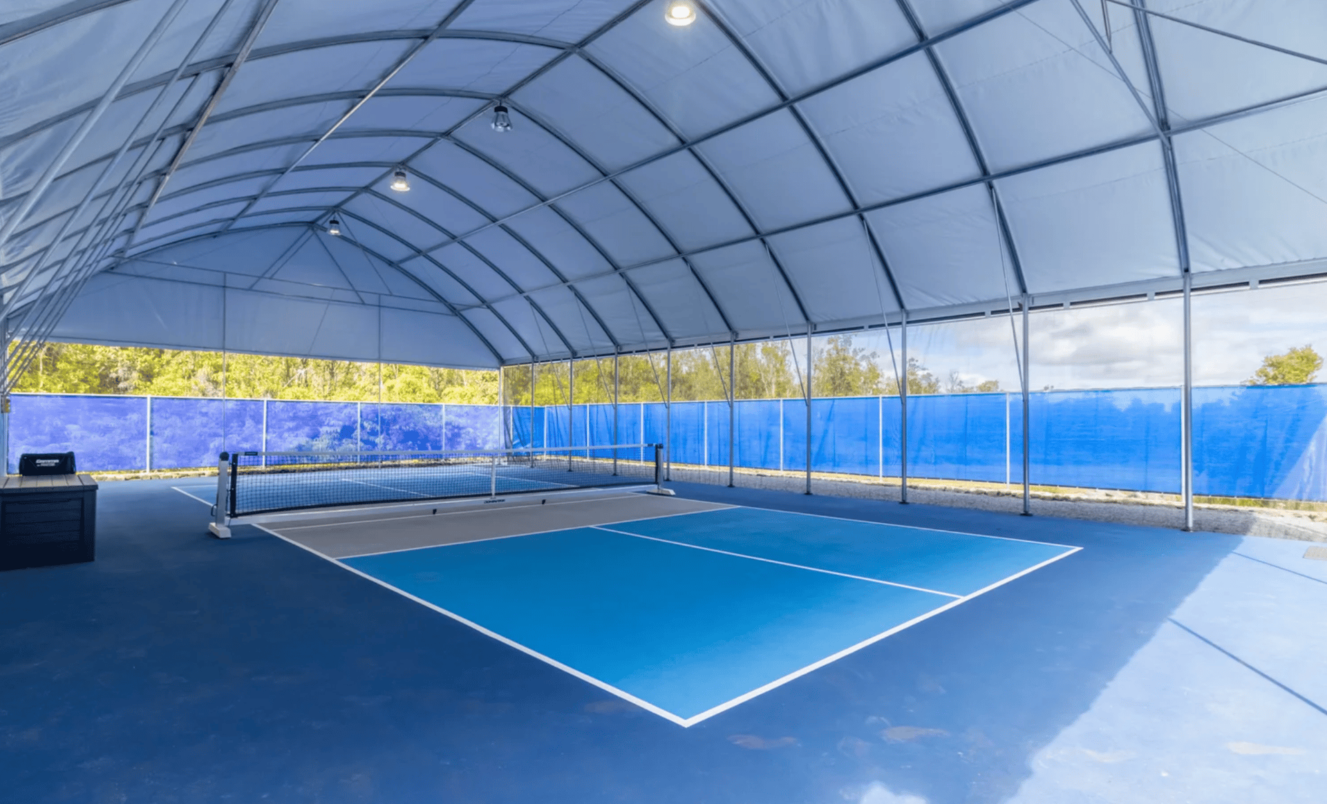 a person holding a tennis ball and a racket