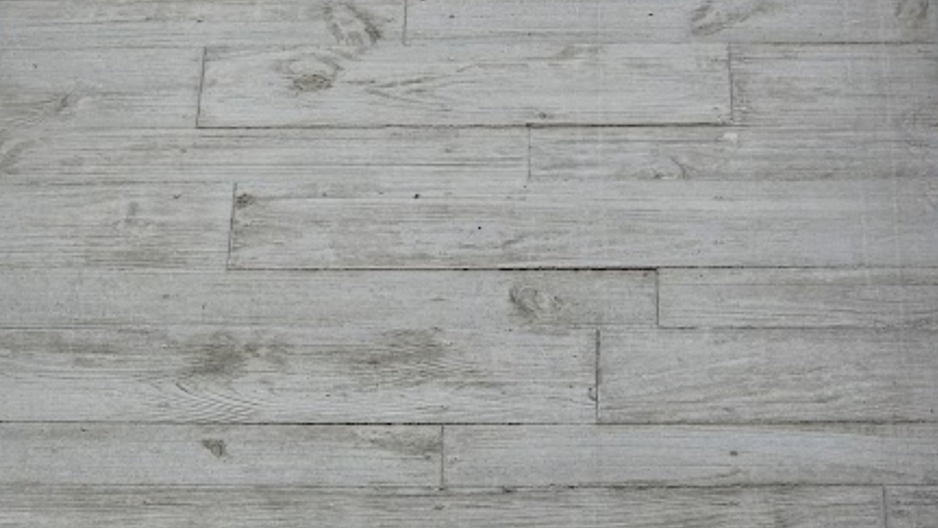 A textured concrete wall with geometric patterns.