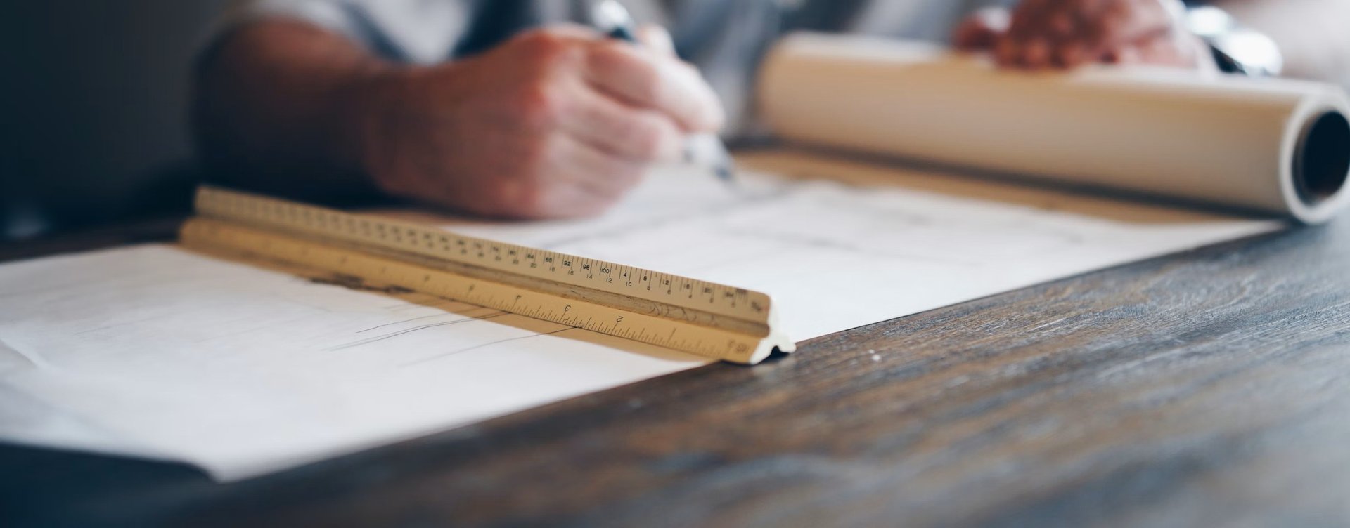 a person sitting at a desk with a calculator and a notebook