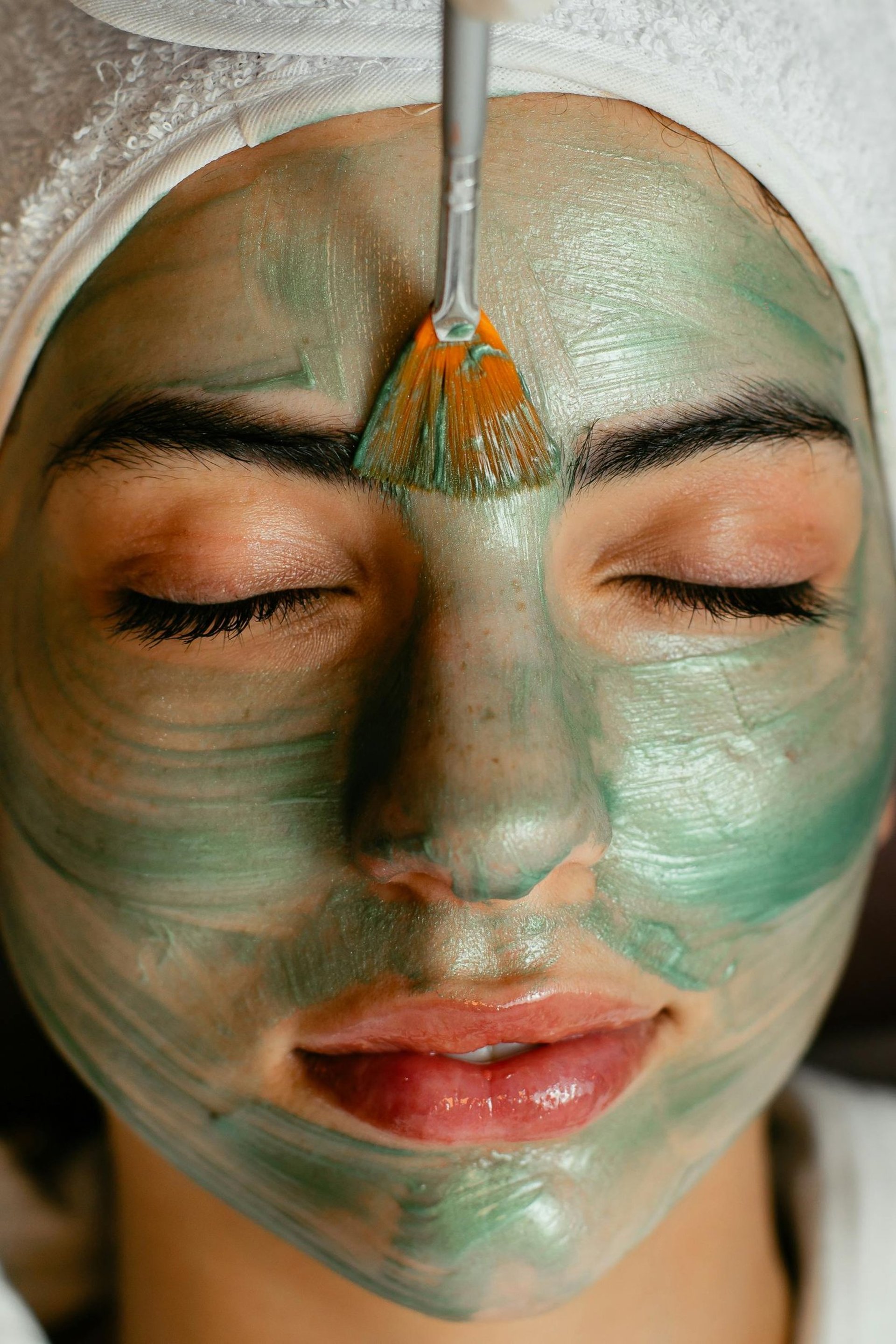 a woman getting a facial massage on her face