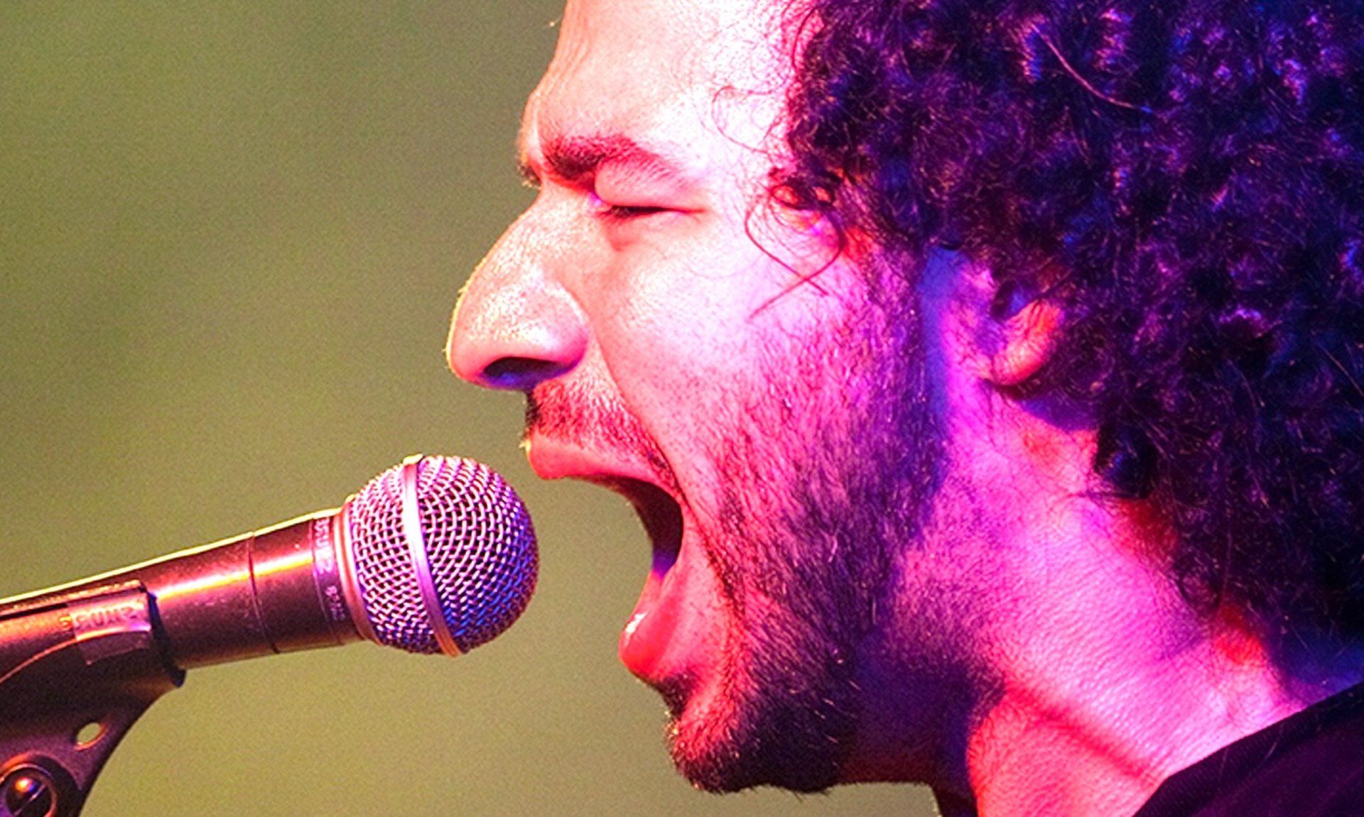 an abstract photo of a curved building with a blue sky in the background