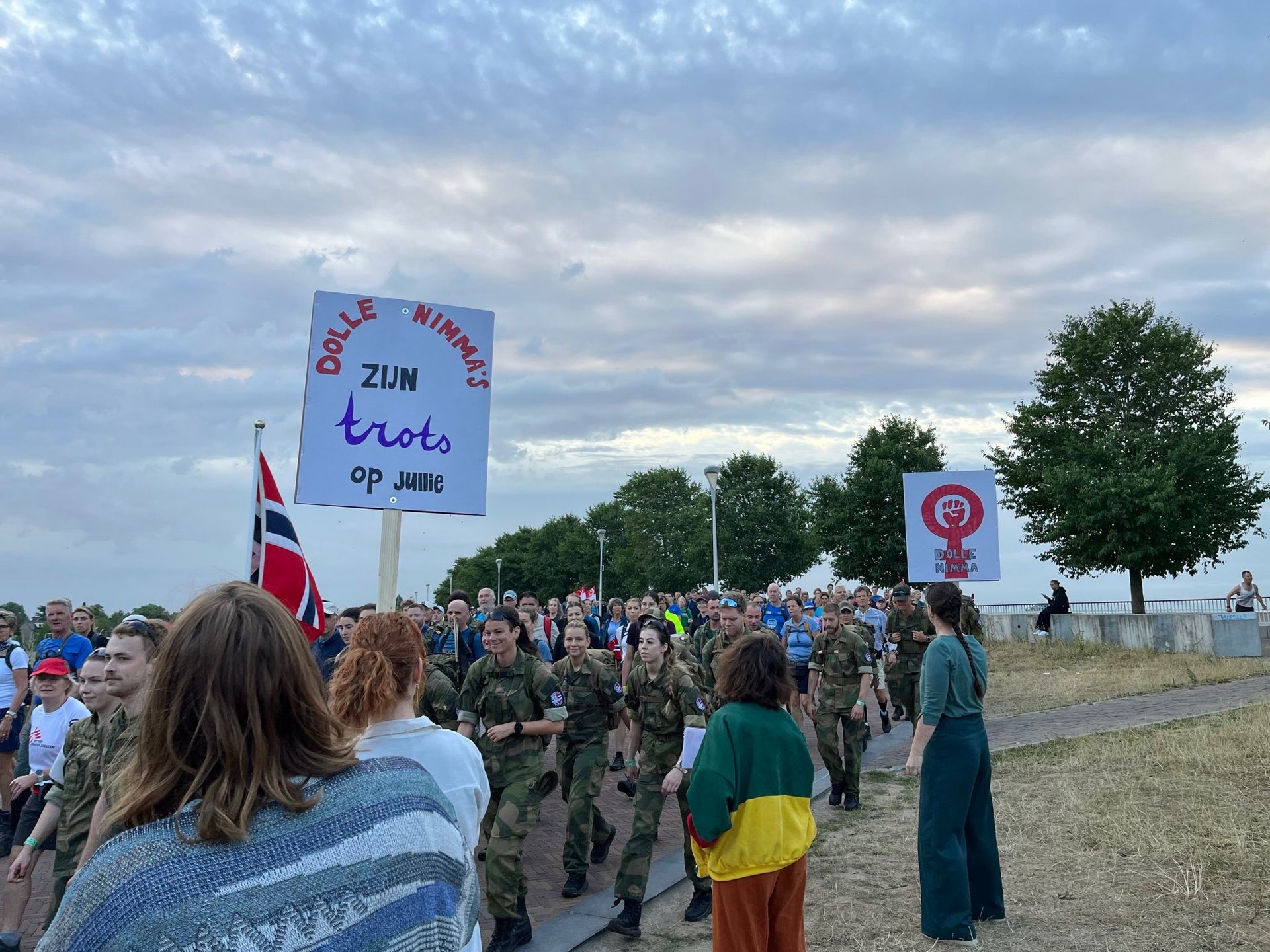 grayscale photo of group of people performing rally on street