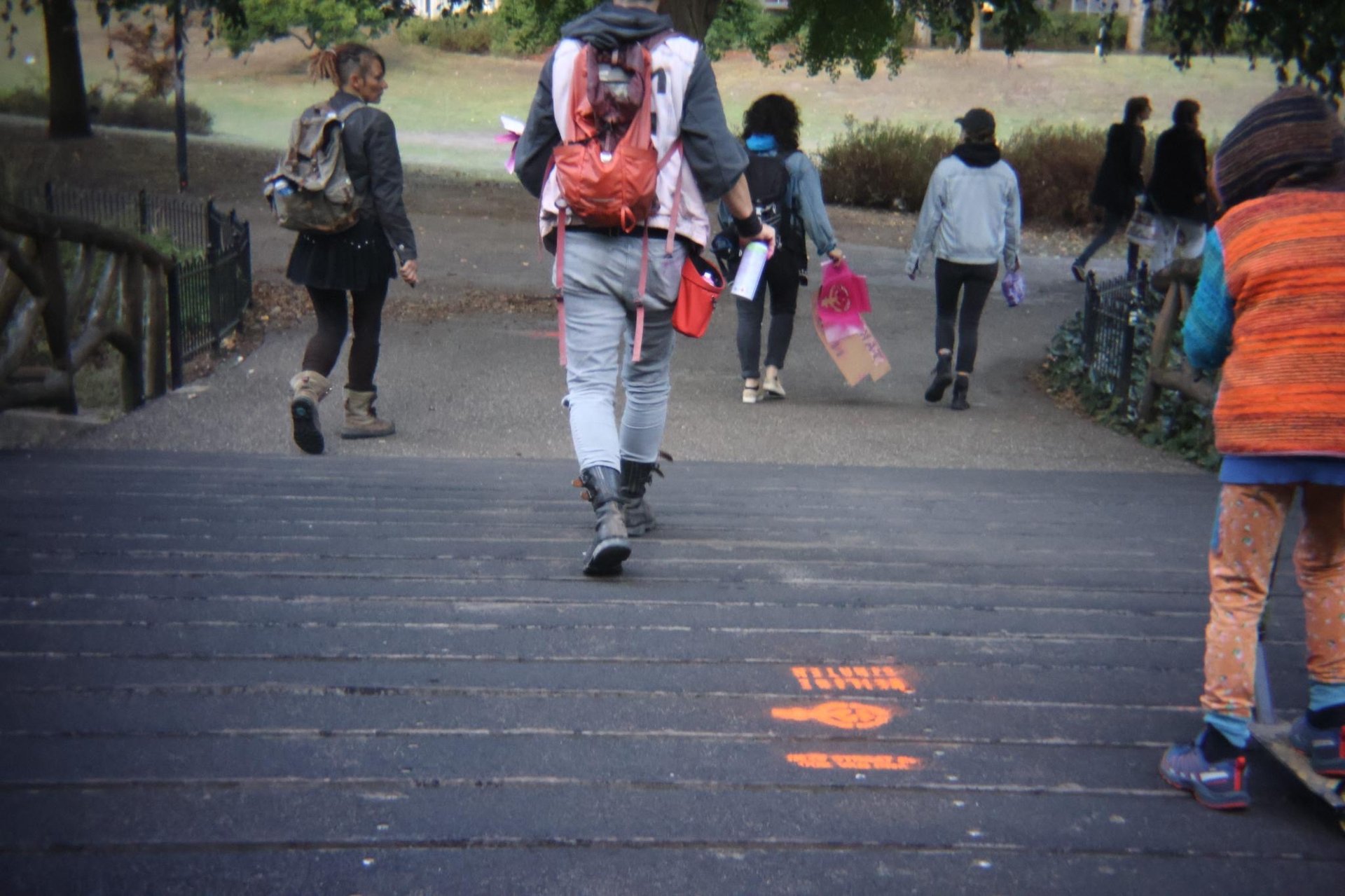 man in blue jacket holding red and white plastic cup