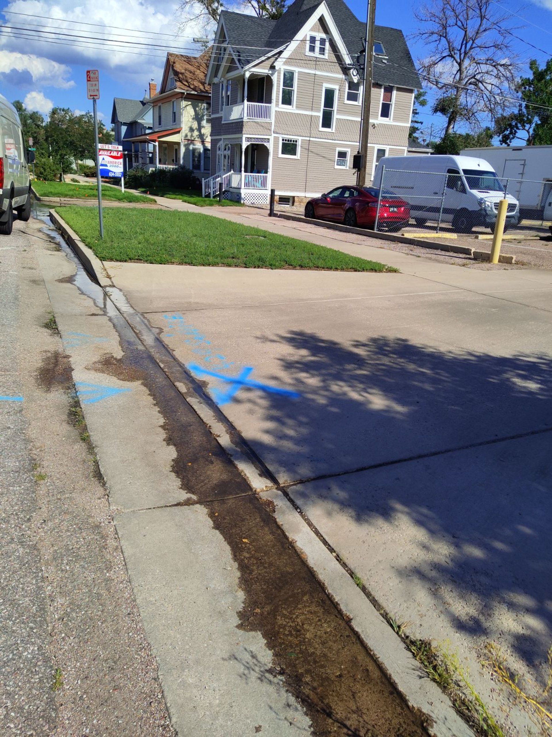 leak marked in street in downtown colorado springs in front of an apartment complex 