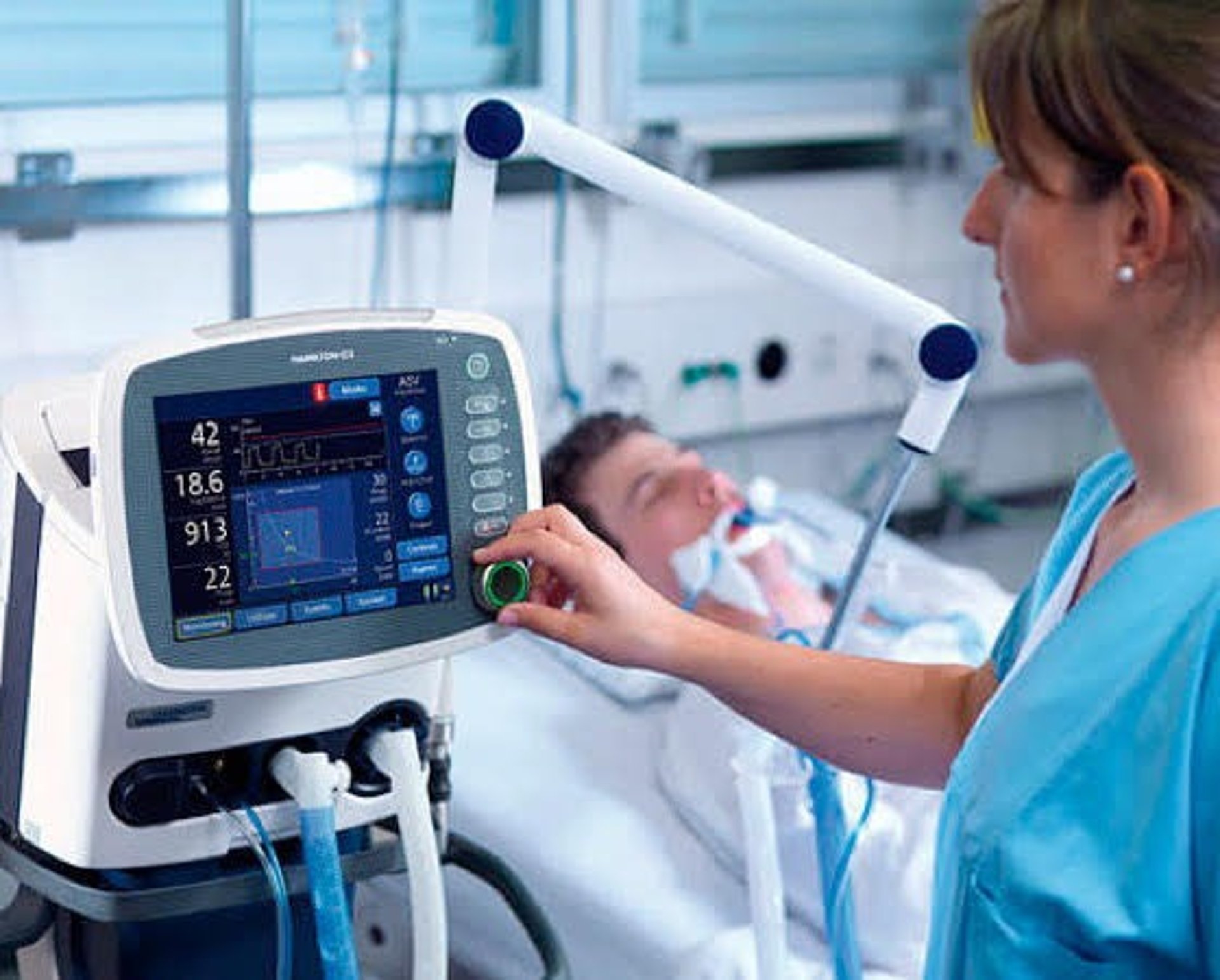 a person in blue gloves is operating a machine
