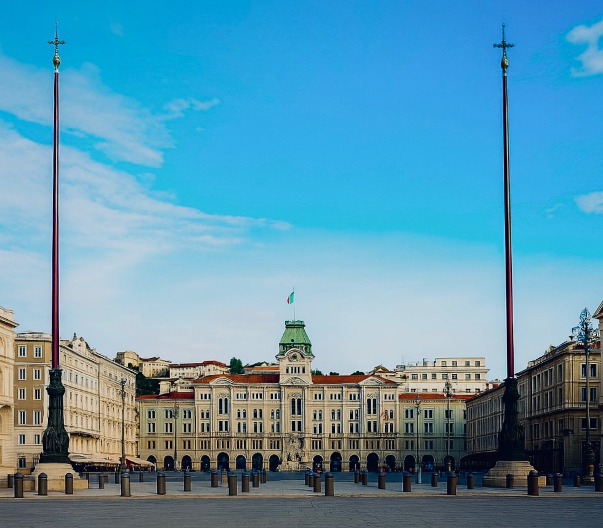 white and brown concrete building near body of water during daytime
