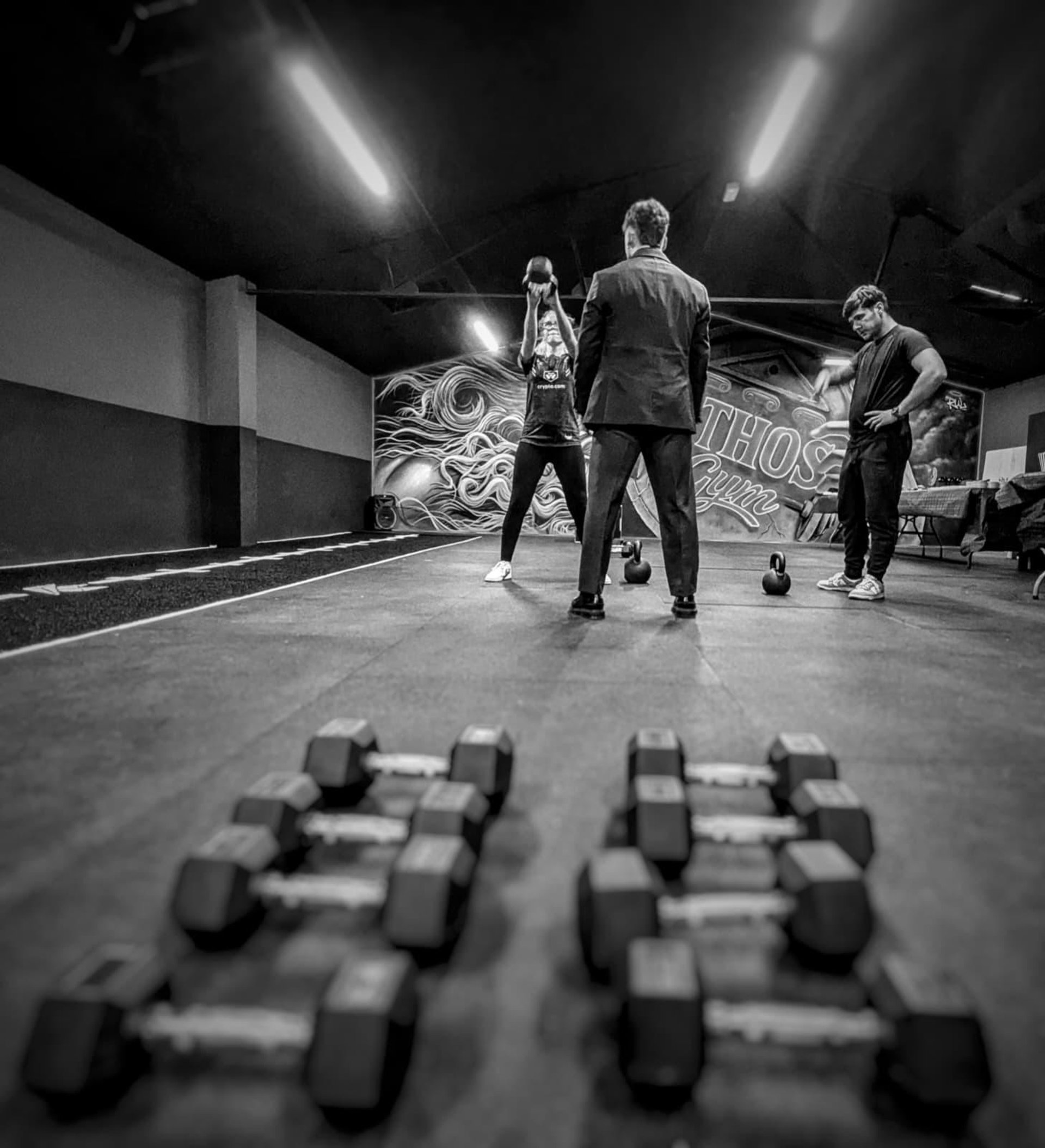 a gym with a row of exercise equipment