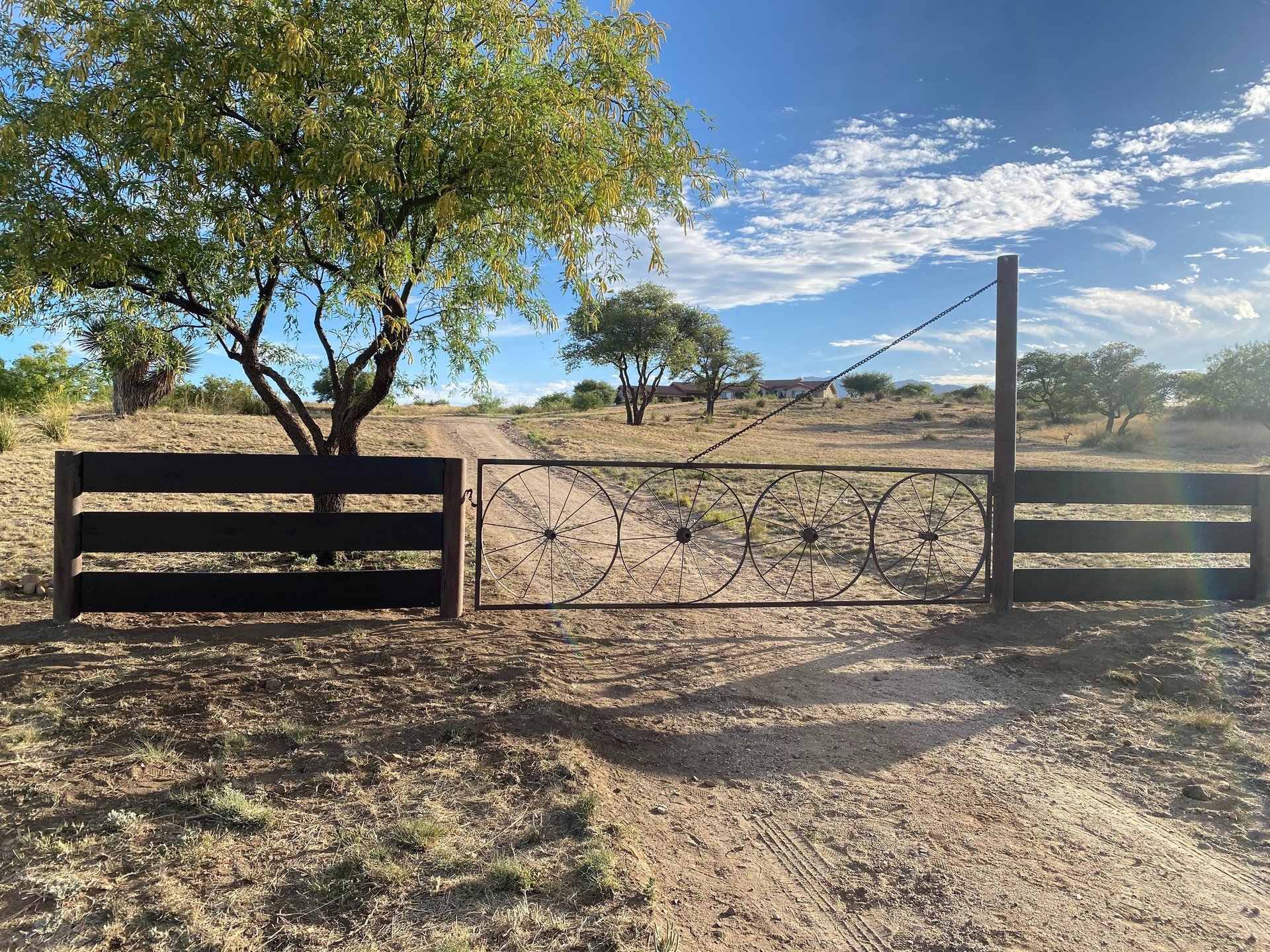A backyard with a deck and a fence