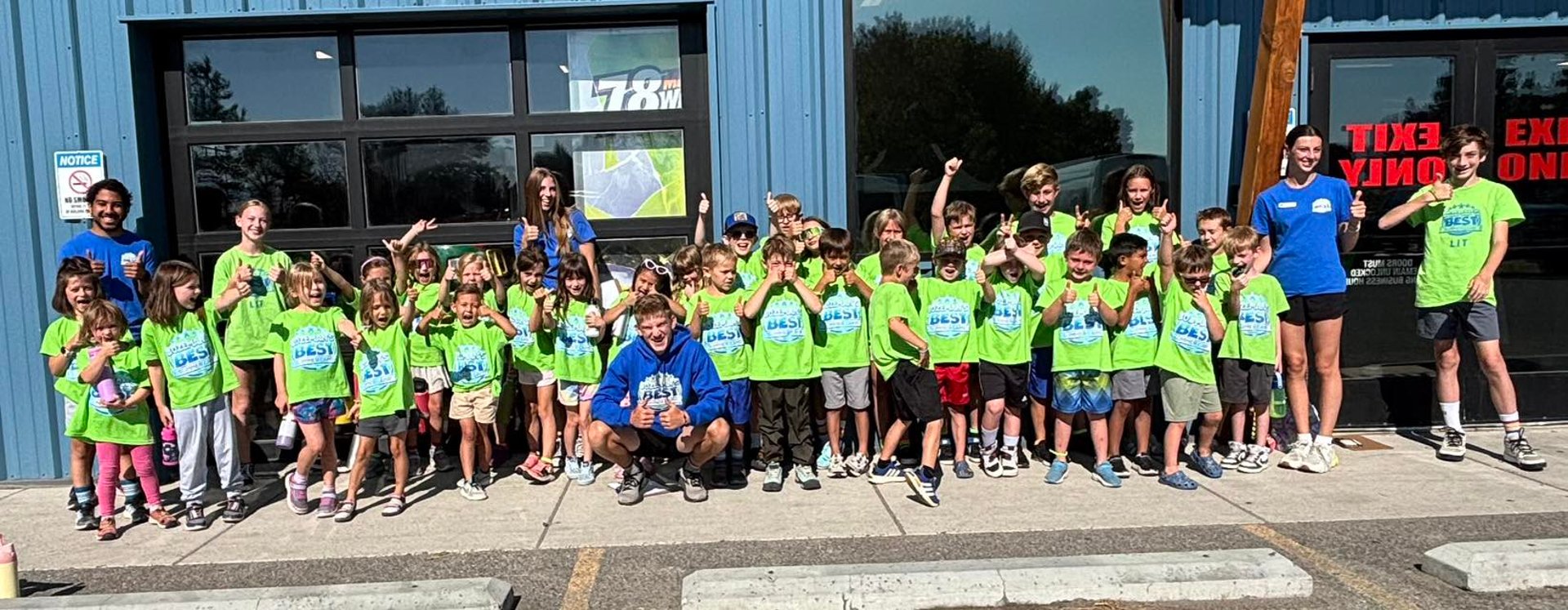 a young boy running through a sprinkle of water