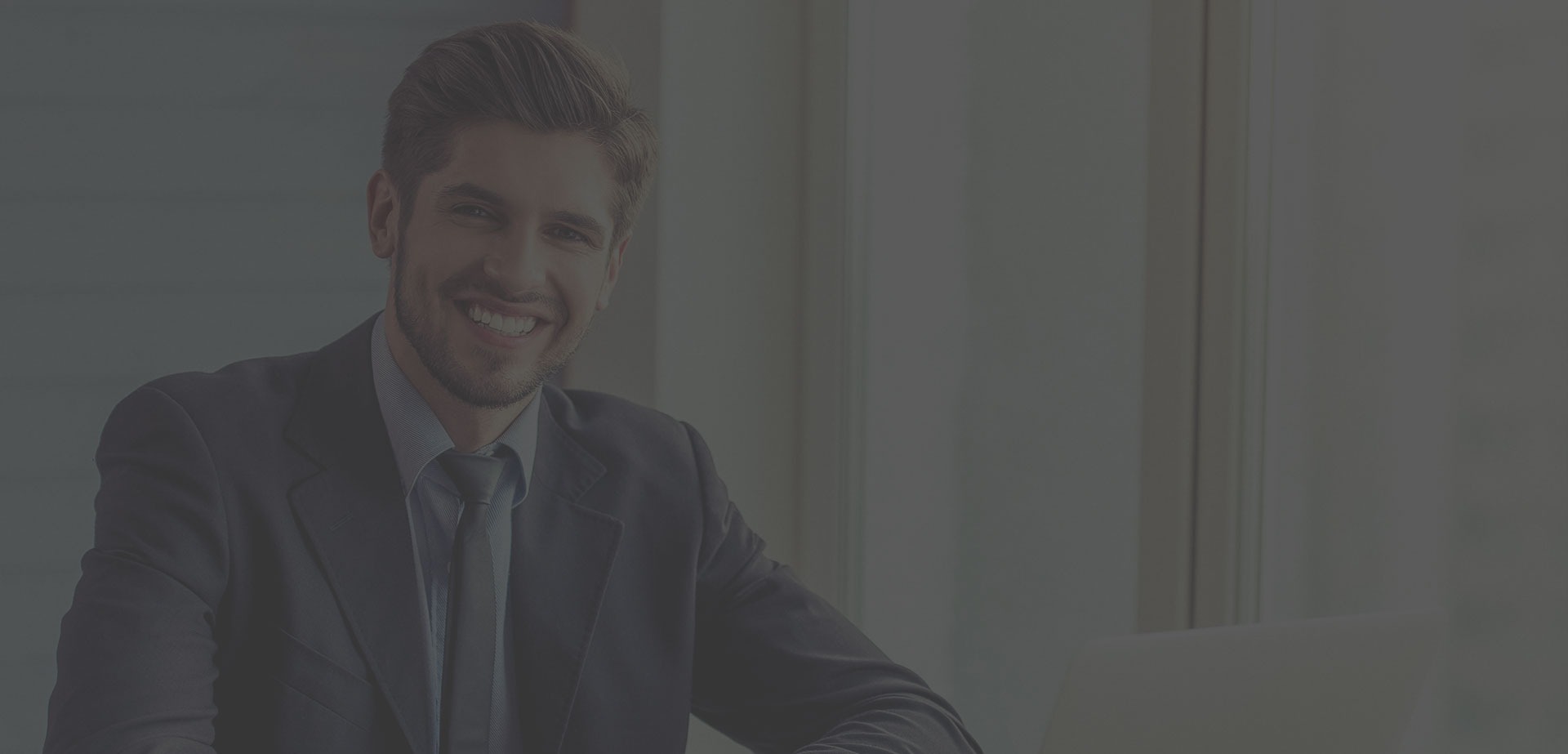 man in black tank top standing near white wall