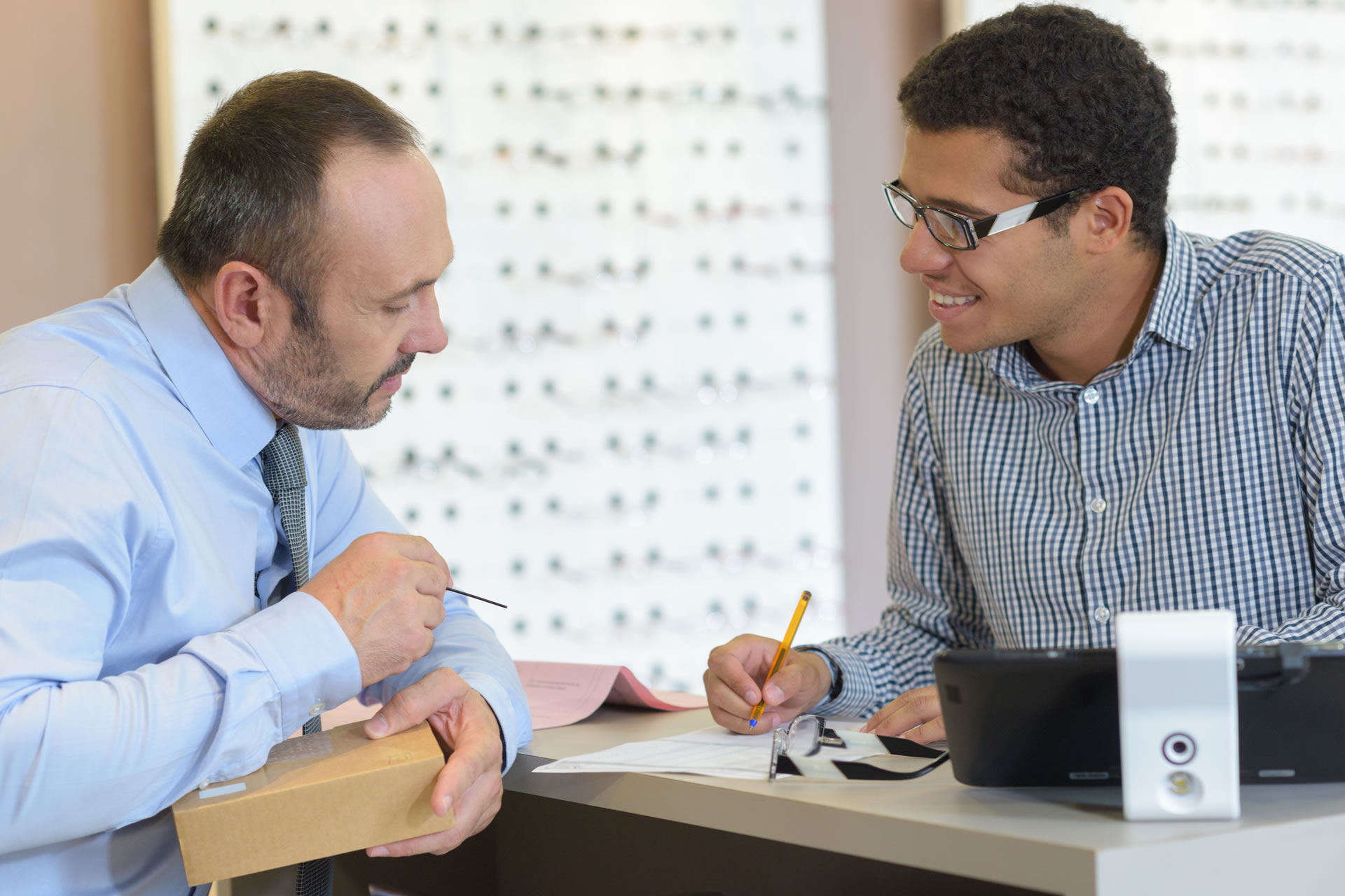 person holding smartphone beside tablet computer