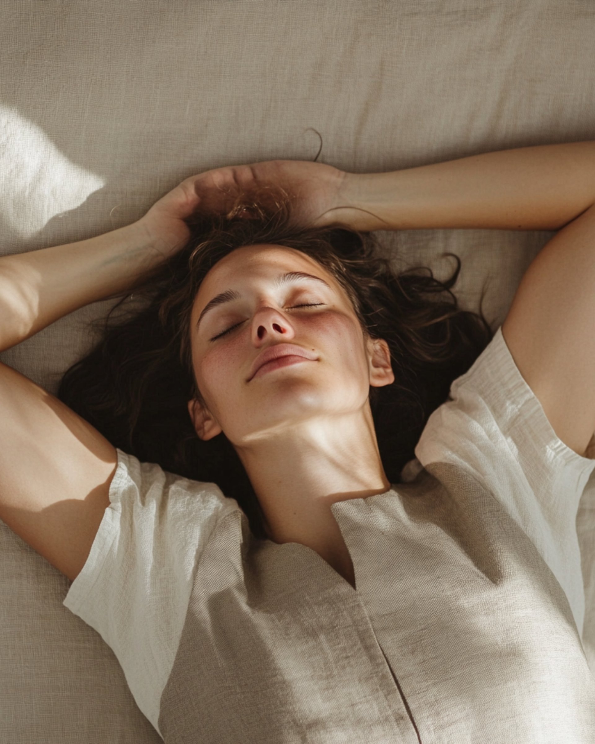 a woman laying on a bed with hot stones on her back