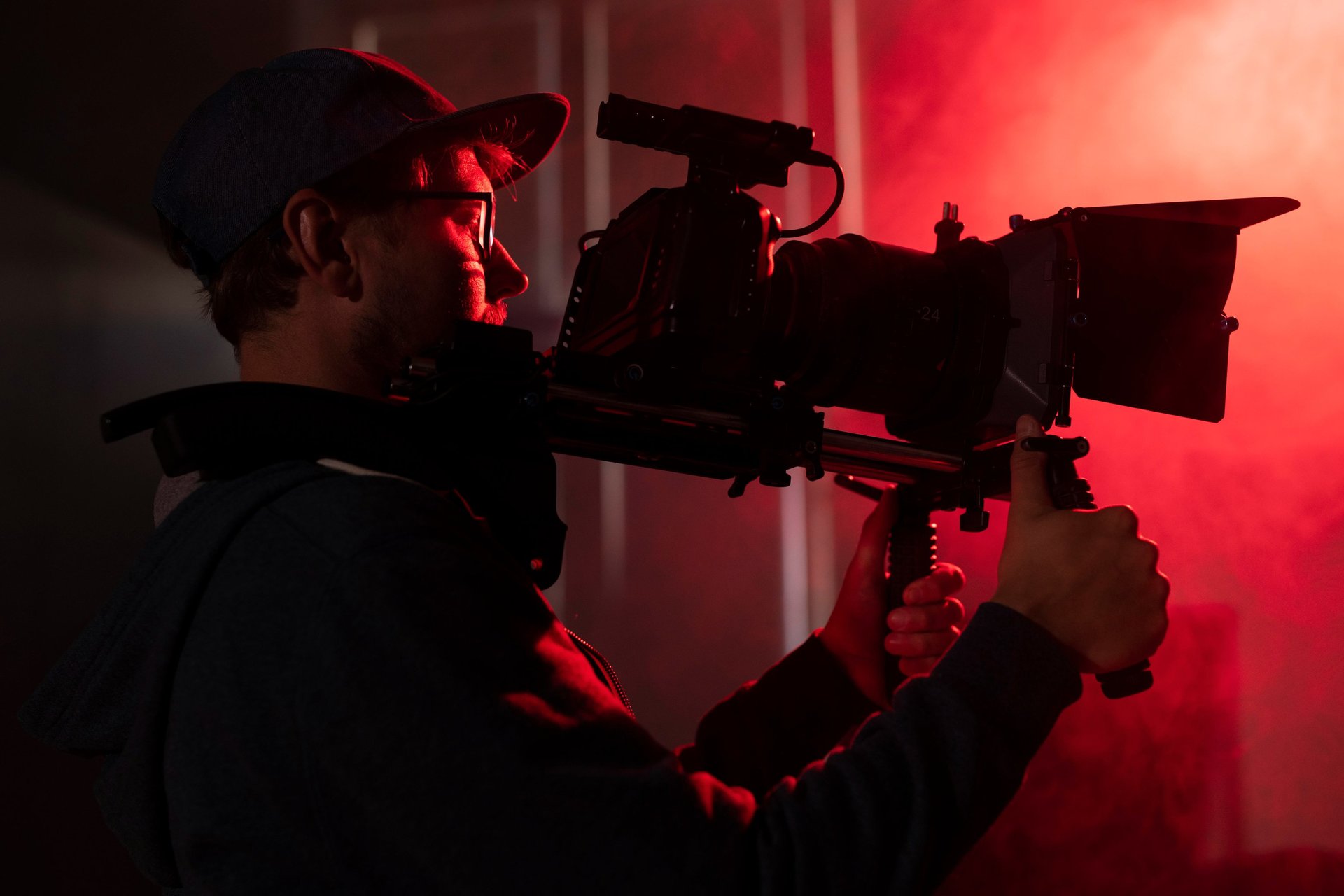 a man with a camera in a dark room