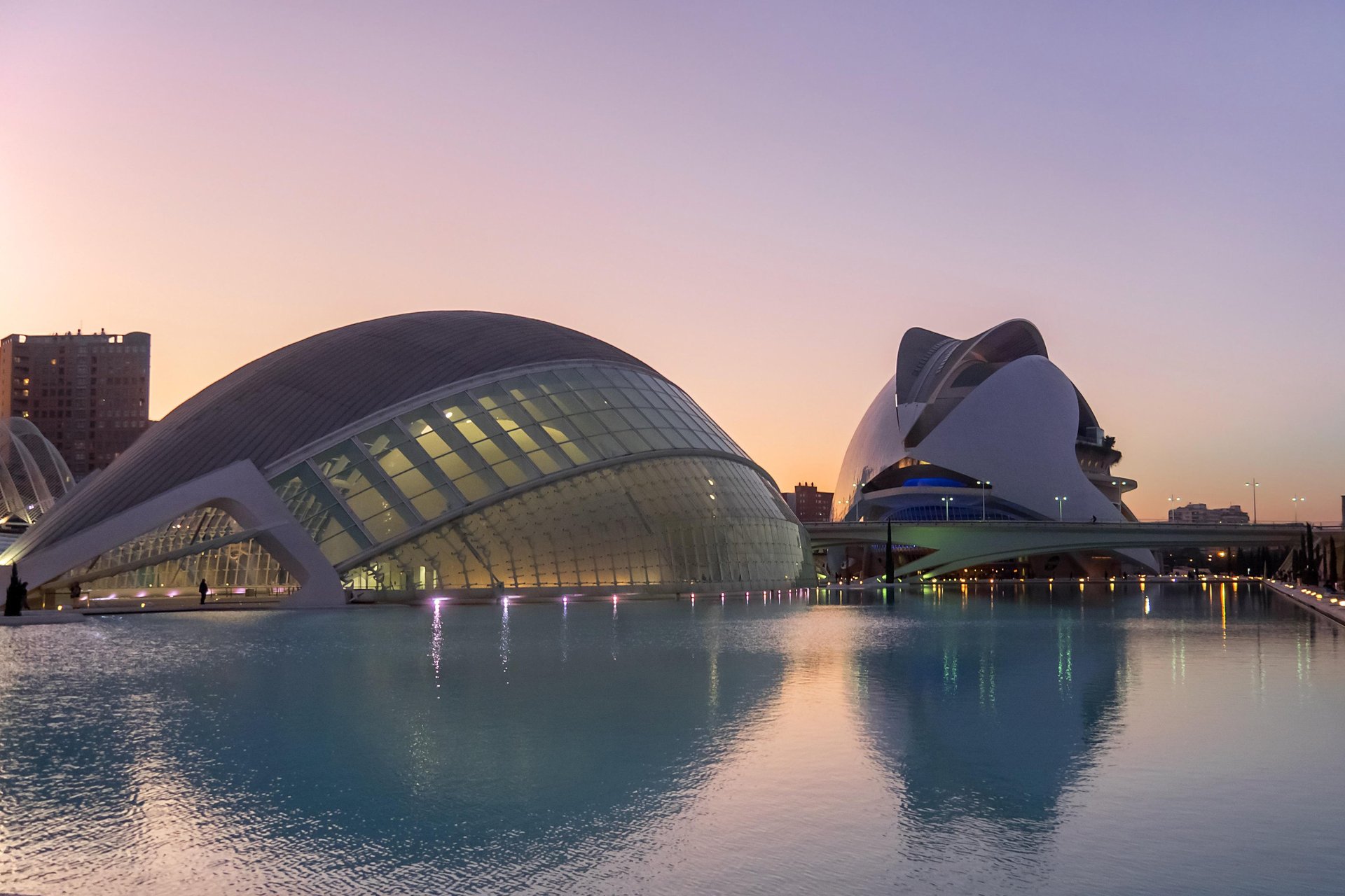 an abstract photo of a curved building with a blue sky in the background