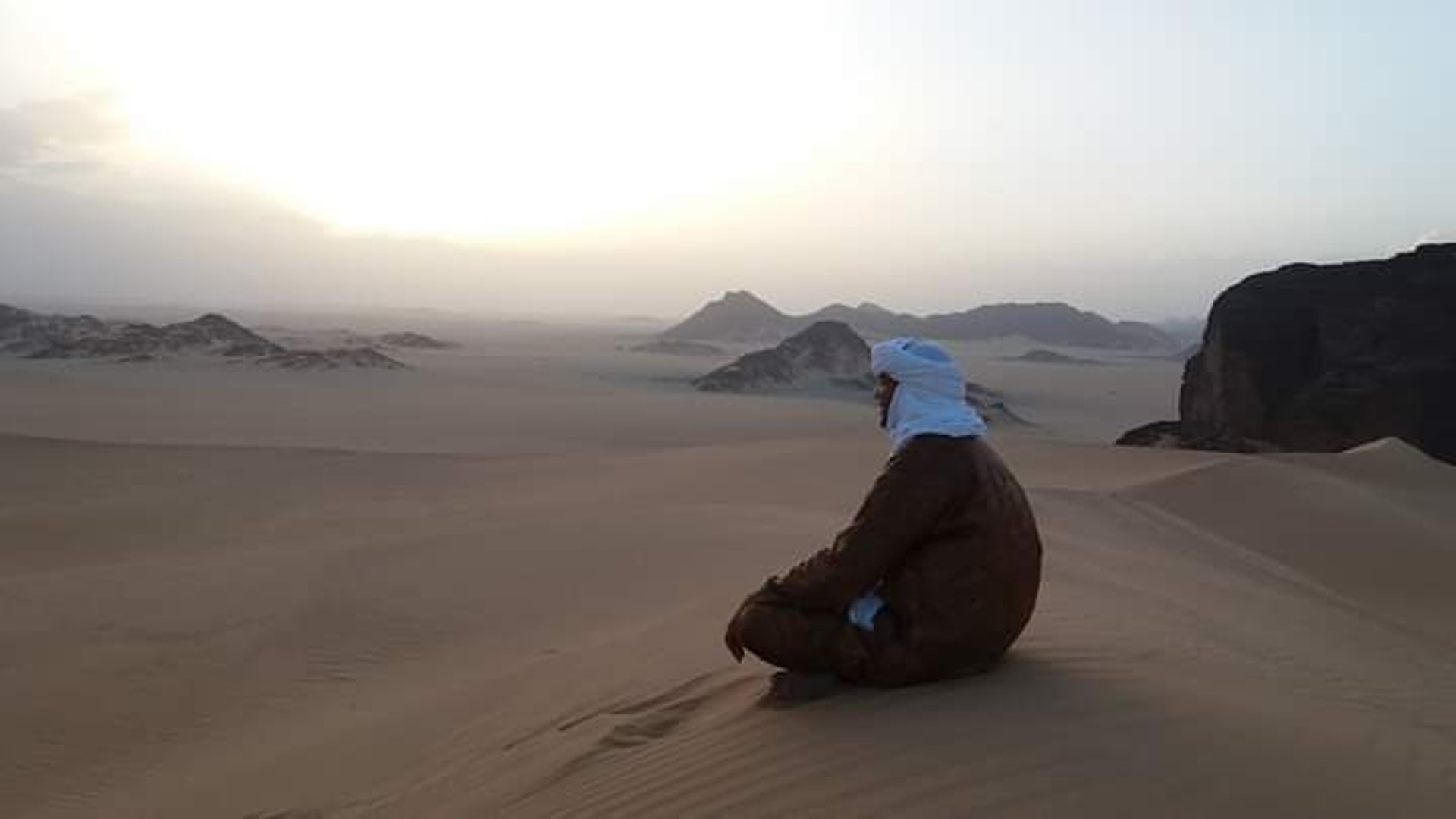 an abstract photo of a curved building with a blue sky in the background