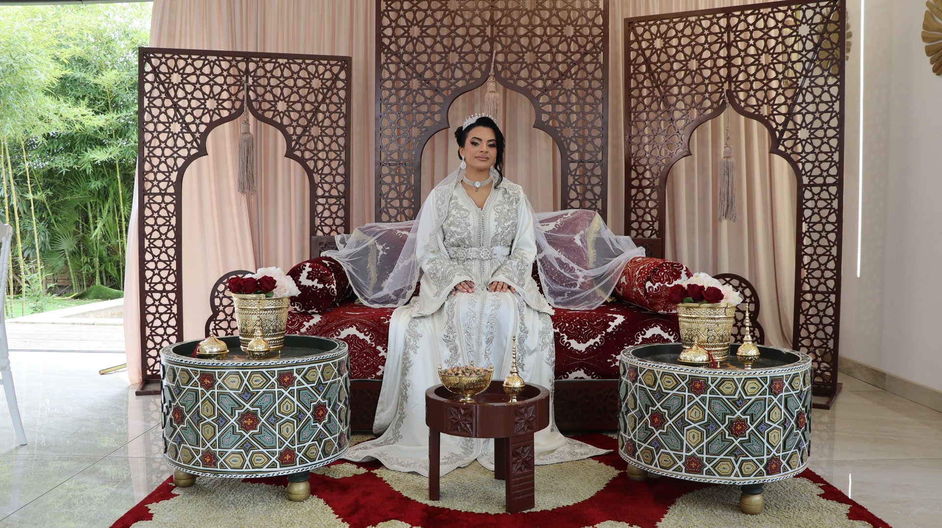 a woman in a red and white dress sitting down