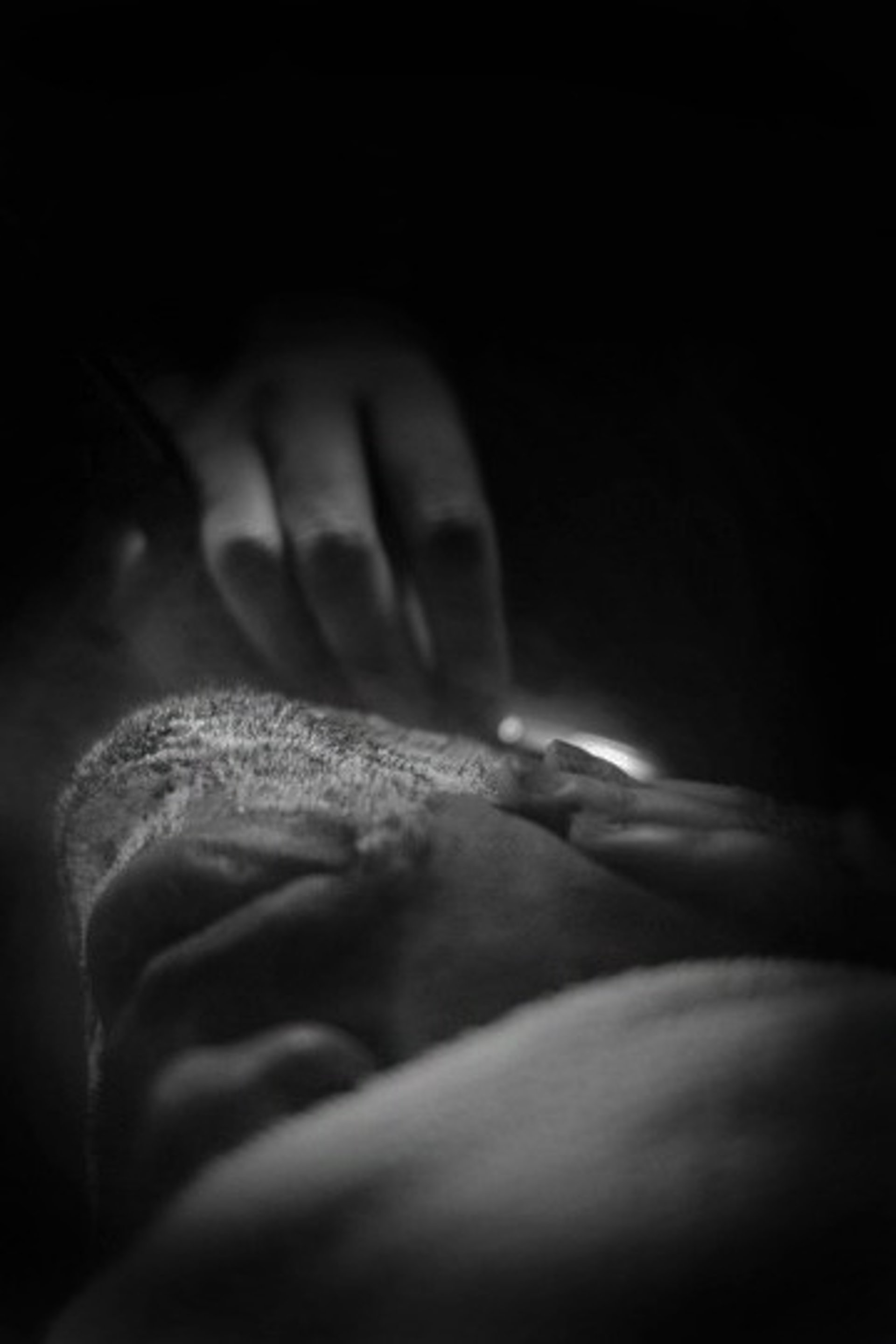 a black and white photo of a person smoking a cigarette