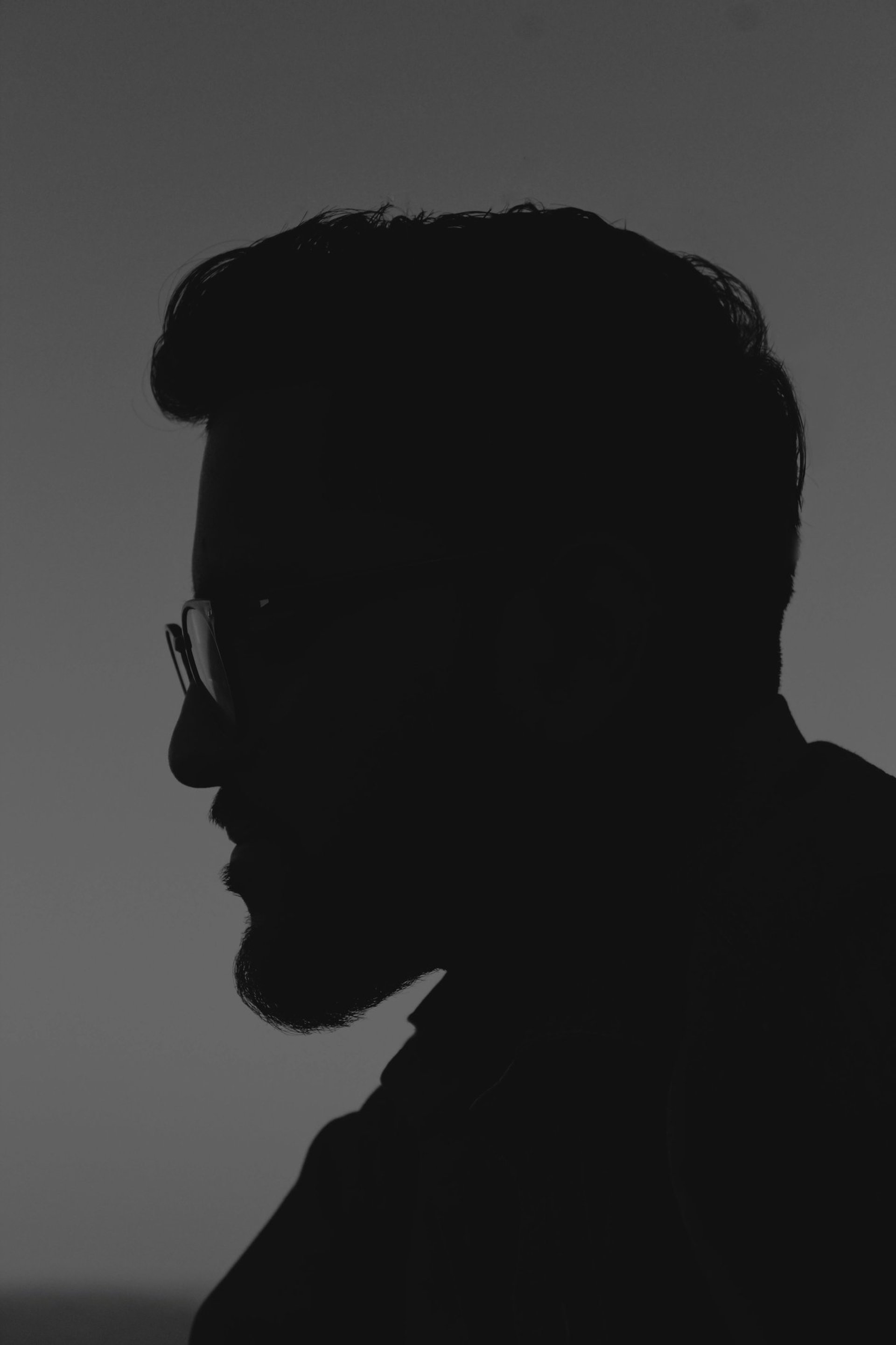 grayscale photo of man wearing blazer