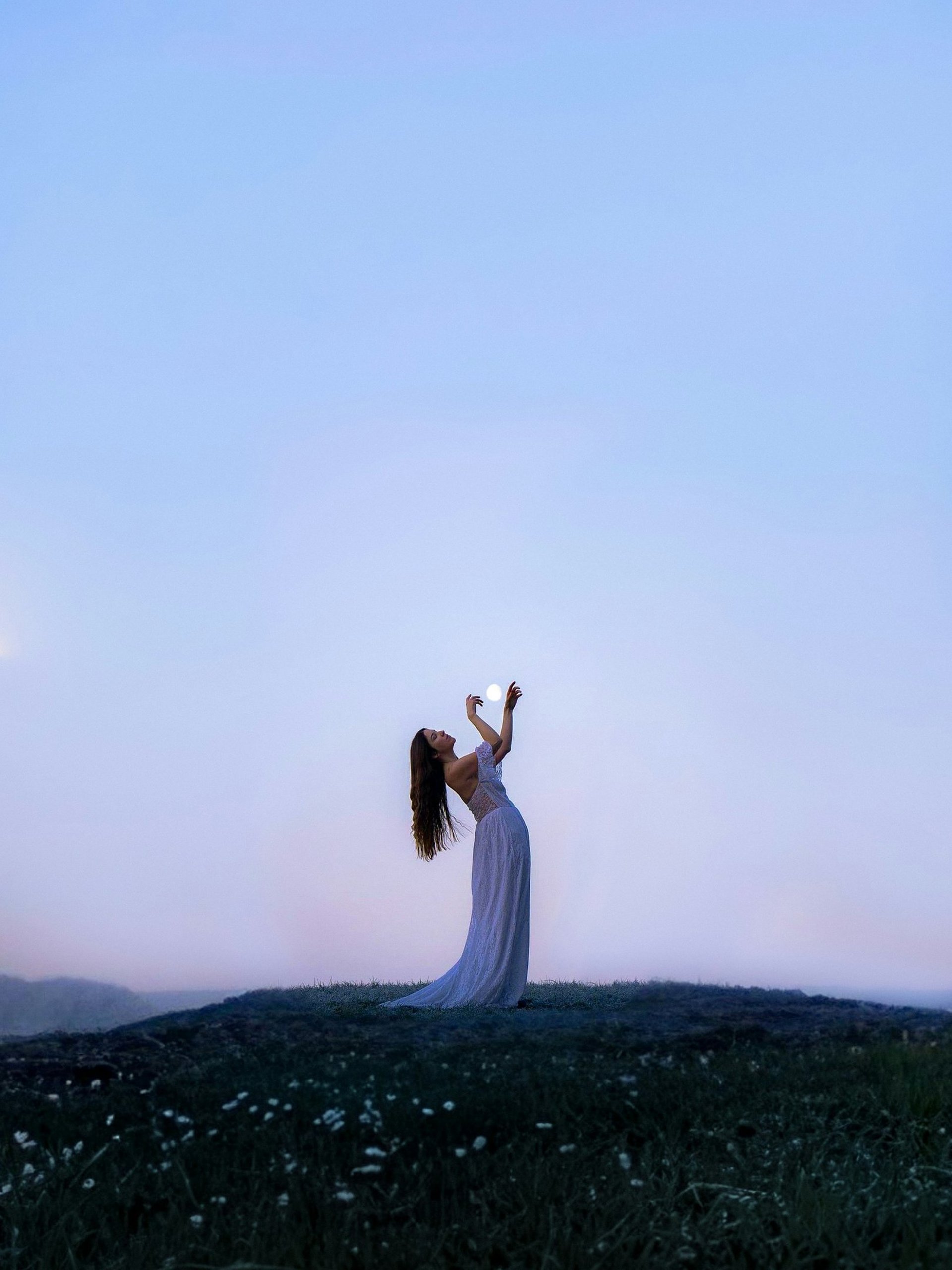 woman wearing yellow long-sleeved dress under white clouds and blue sky during daytime