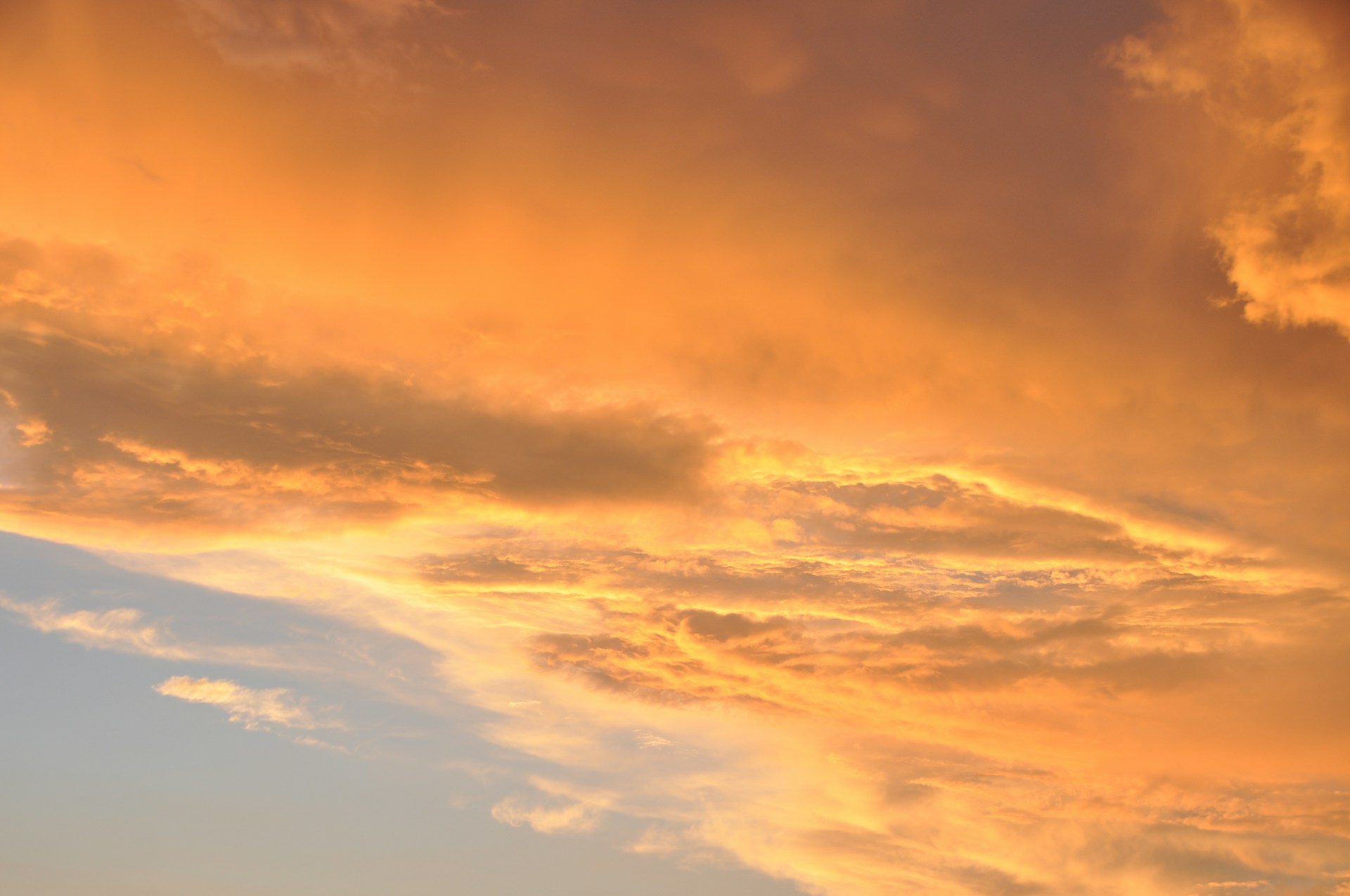 woman wearing yellow long-sleeved dress under white clouds and blue sky during daytime