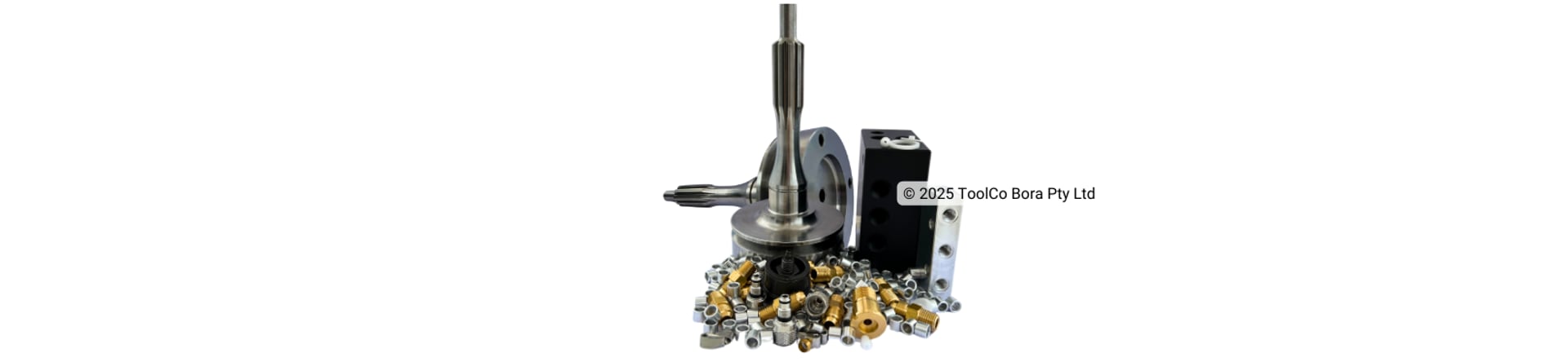 A collection of many machined steel, acetal, aluminium and brass parts on a white background