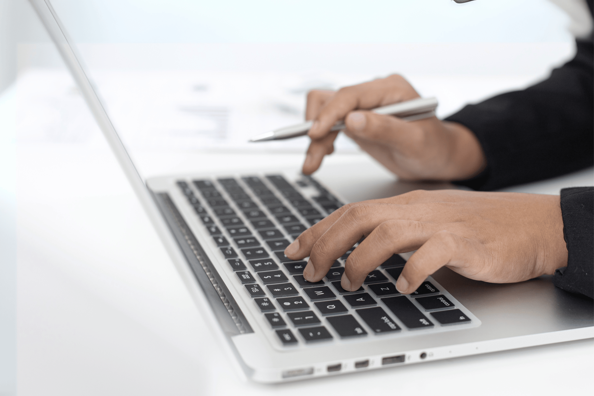person using laptop computer beside aloe vera