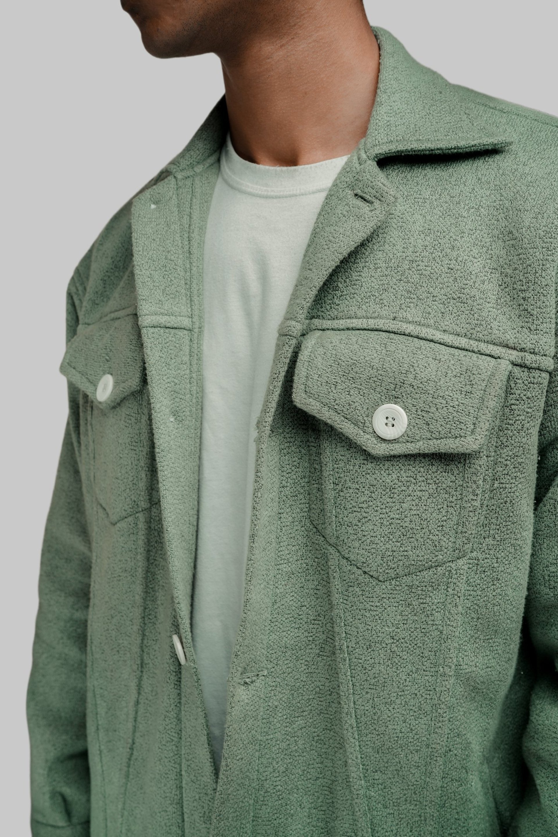 person wearing grey knit sweater
