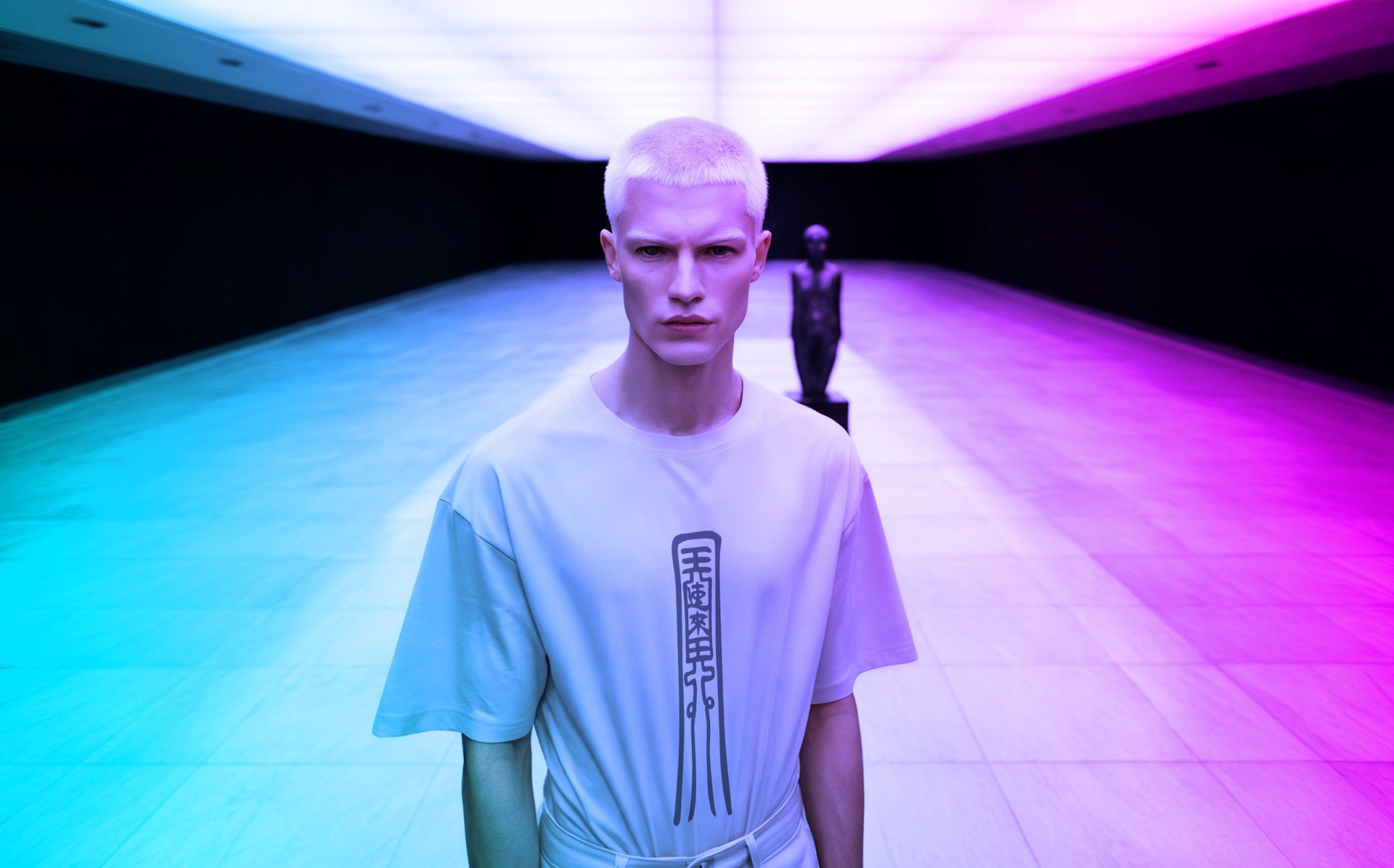 man model wearing Fulutee white T-shirt with Fu talisman Charismatic Enchanter design, standing in a neon-lit hallway