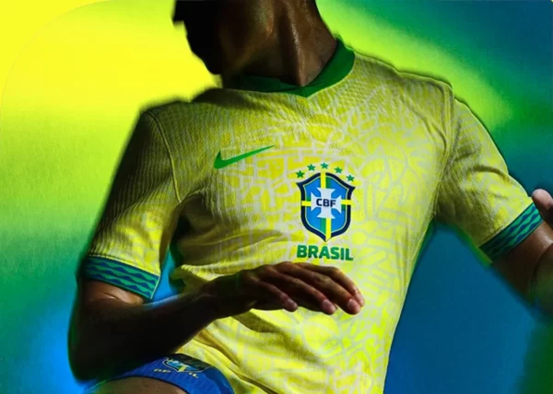 a man wearing a yellow shirt with a brazil emblem on it