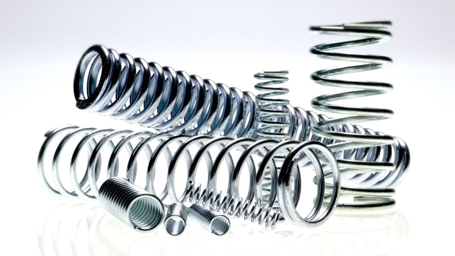 Metal springs are stacked in a warehouse.