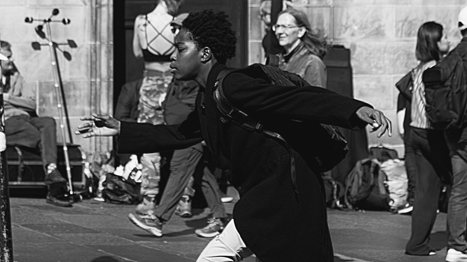 A boy, freeze framed, as he runs up The High Street, Edinburgh