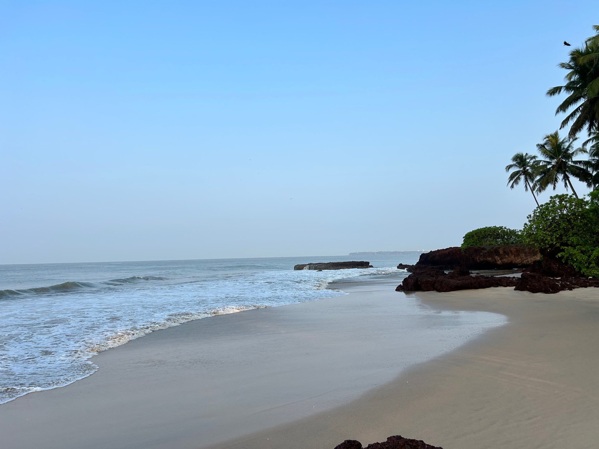 Beach houses sit along the stormy coast.