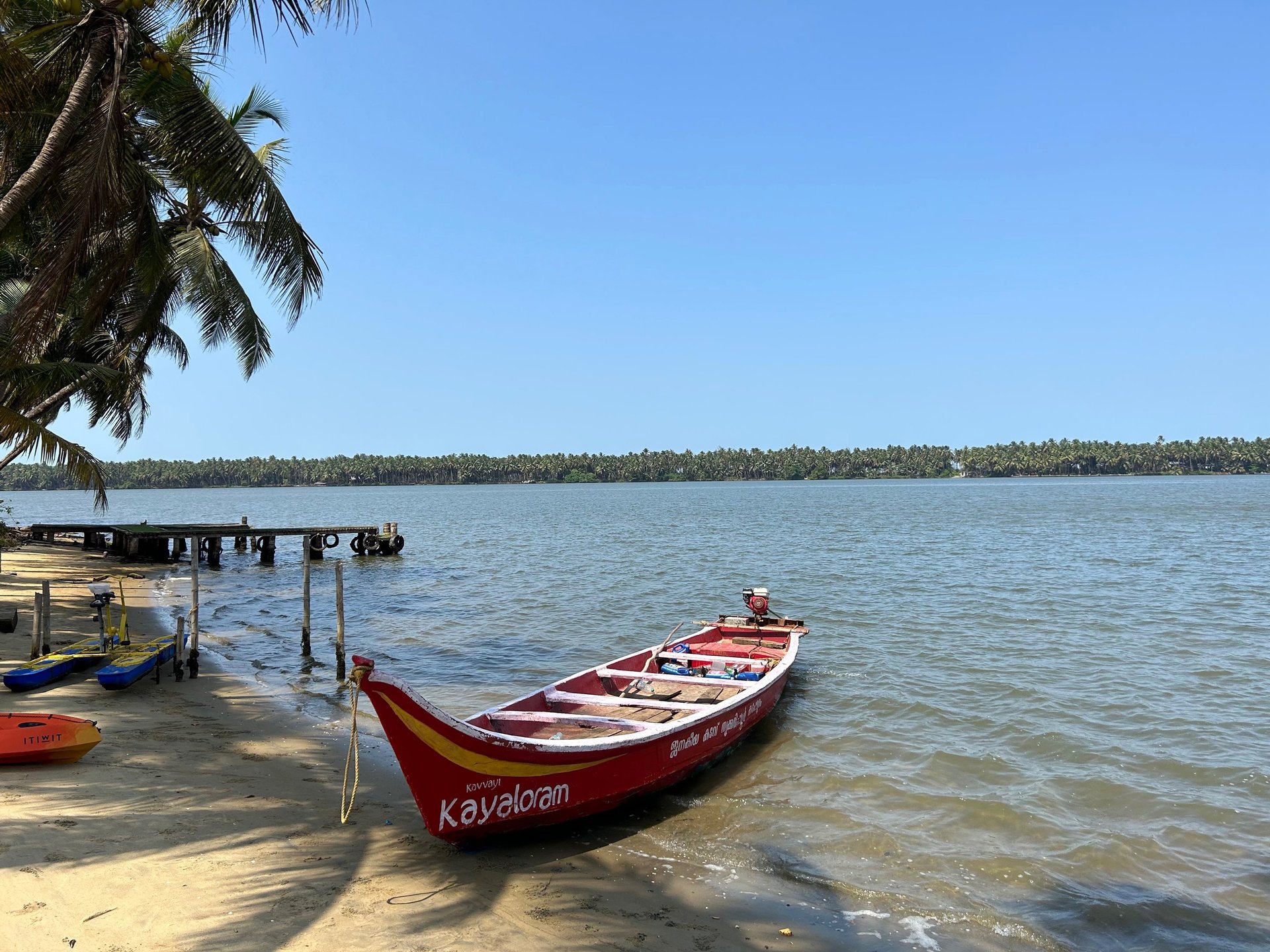 man standing on blue boat during cloudy day