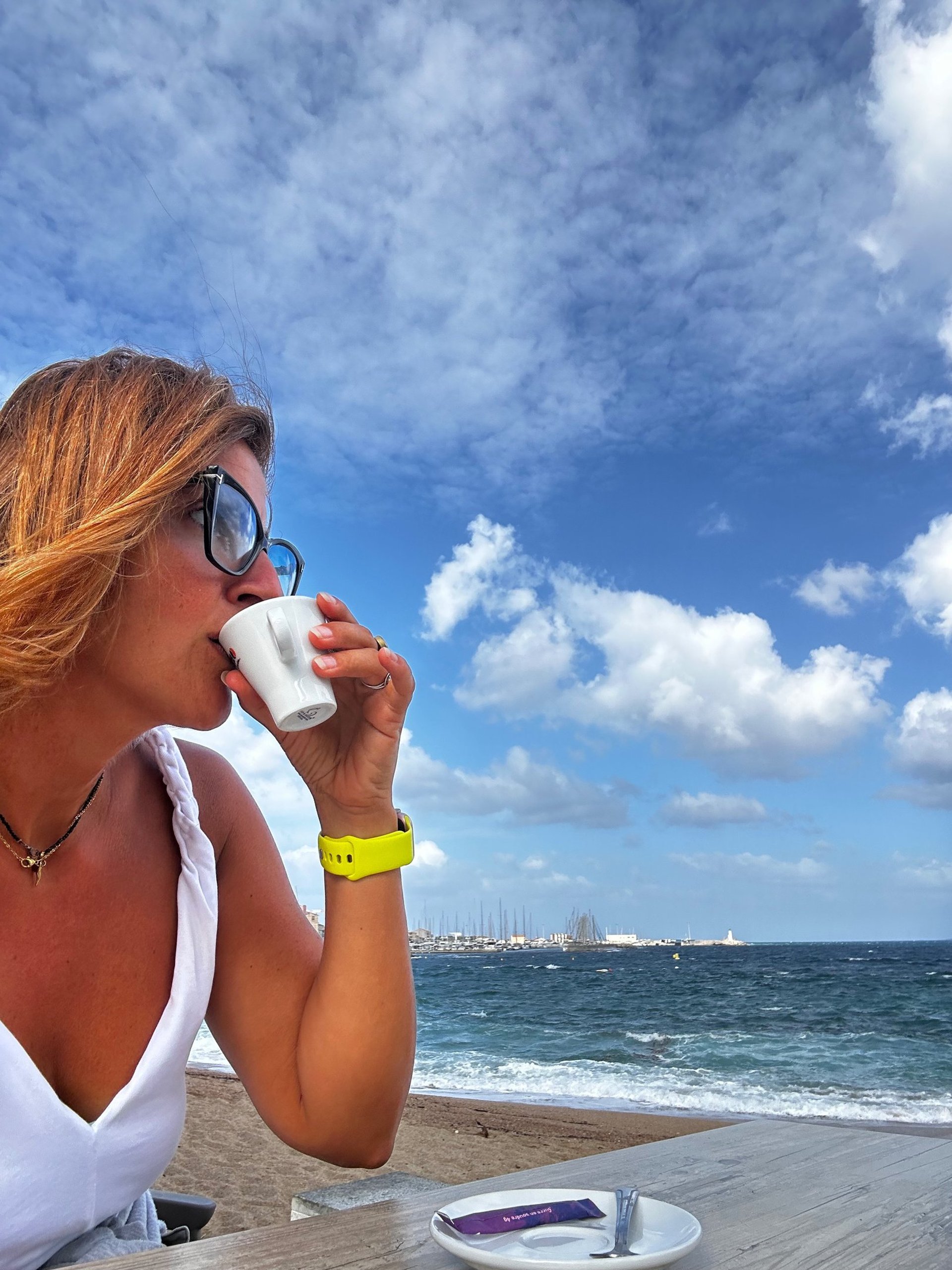 woman wearing yellow long-sleeved dress under white clouds and blue sky during daytime