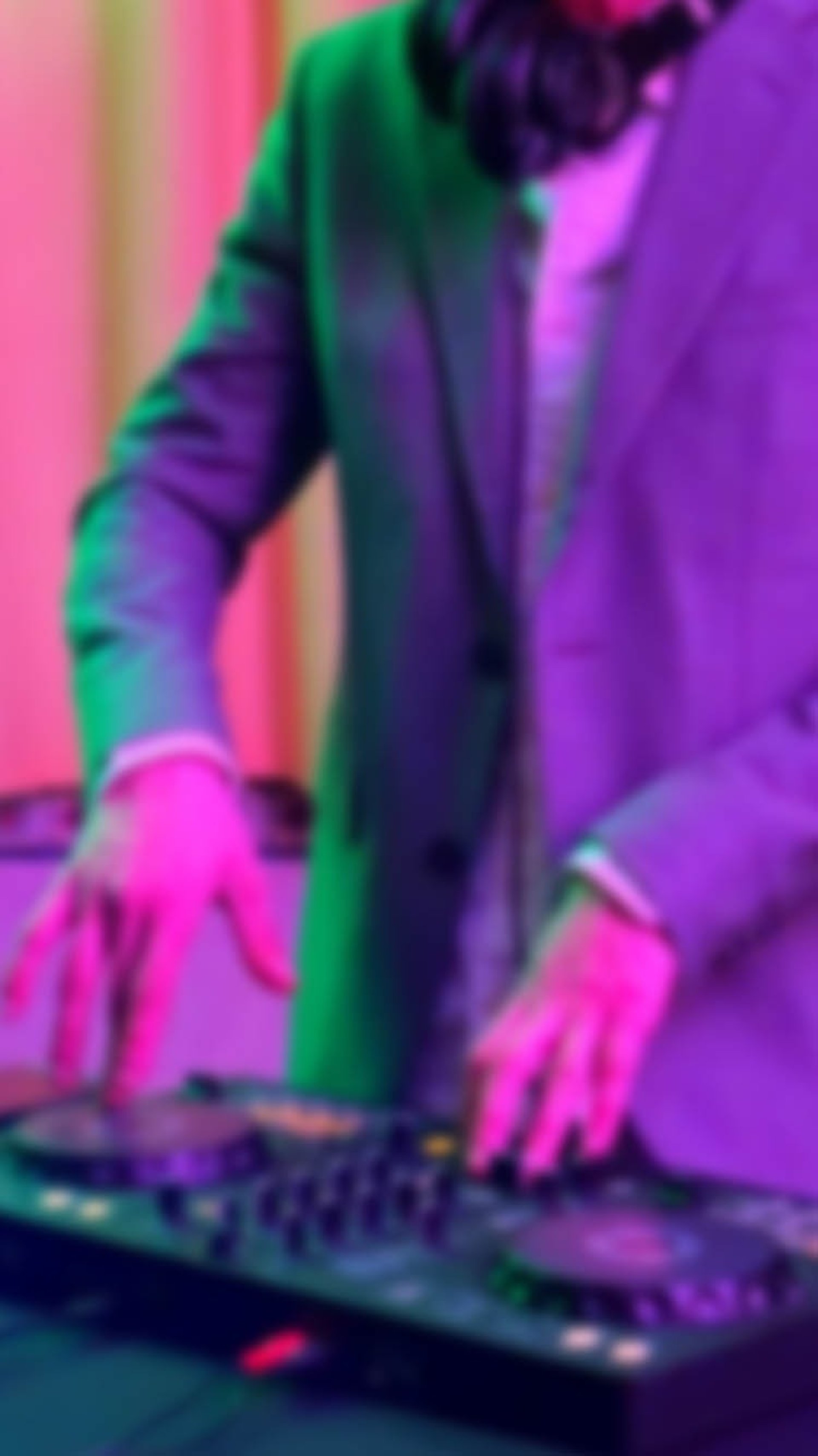 selective focus silhouette photography of man playing red-lighted DJ terminal