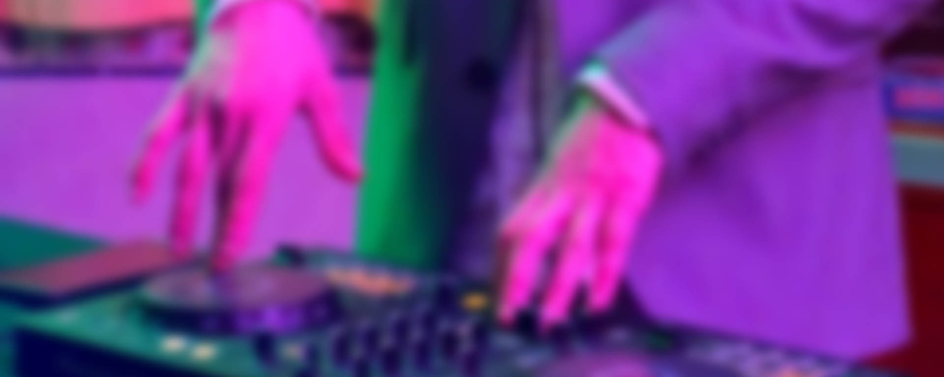 selective focus silhouette photography of man playing red-lighted DJ terminal