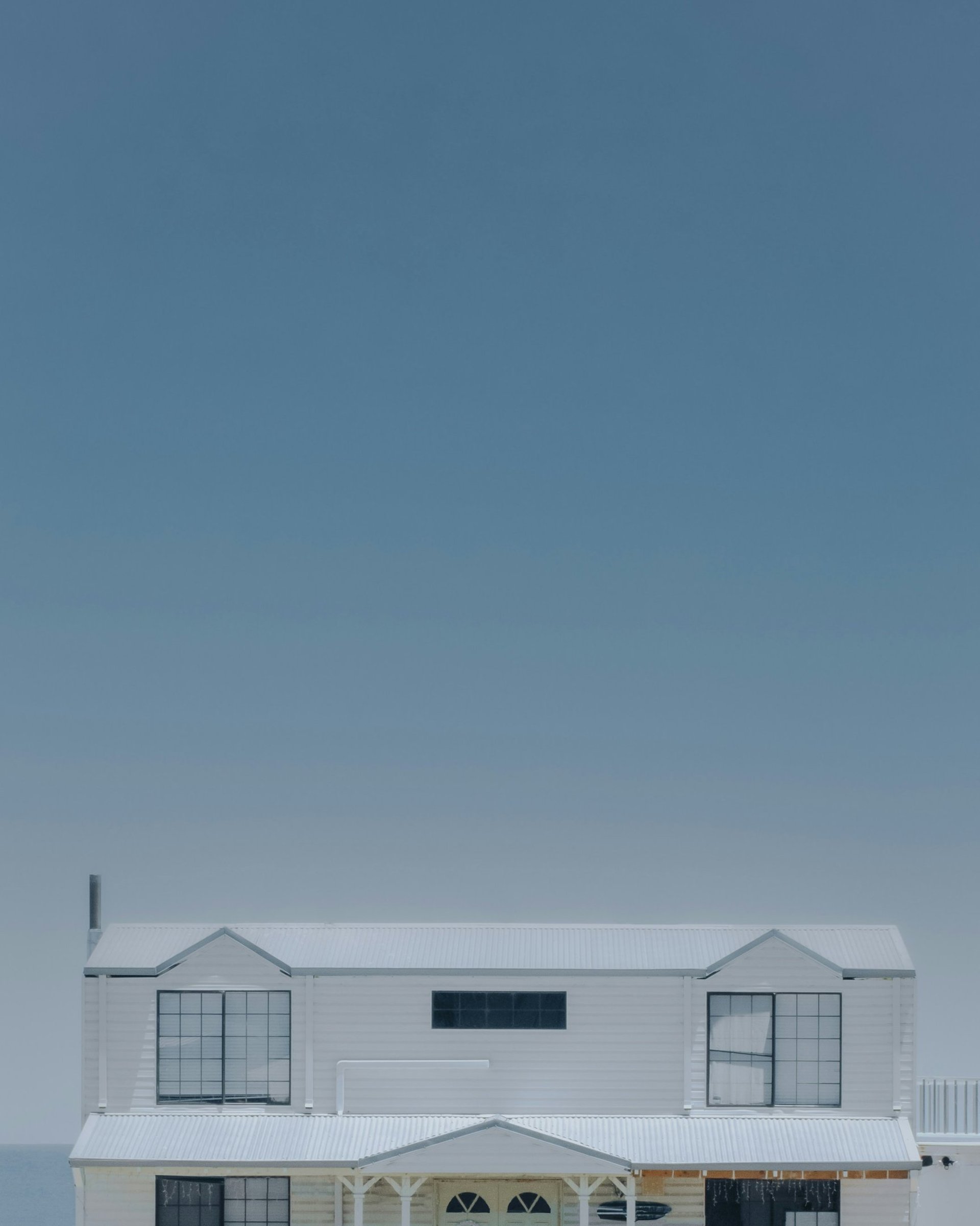 three assorted-color houses next to each other