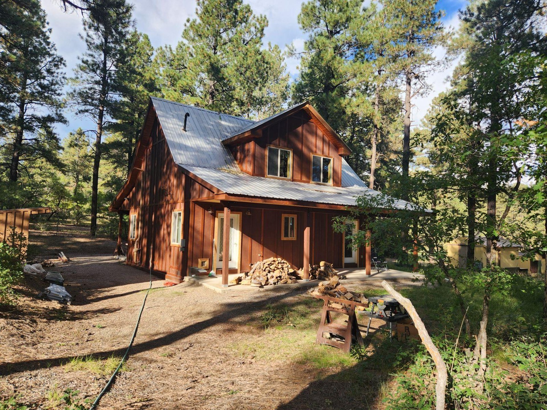 brown wooden house near lake surrounded by green trees during daytime
