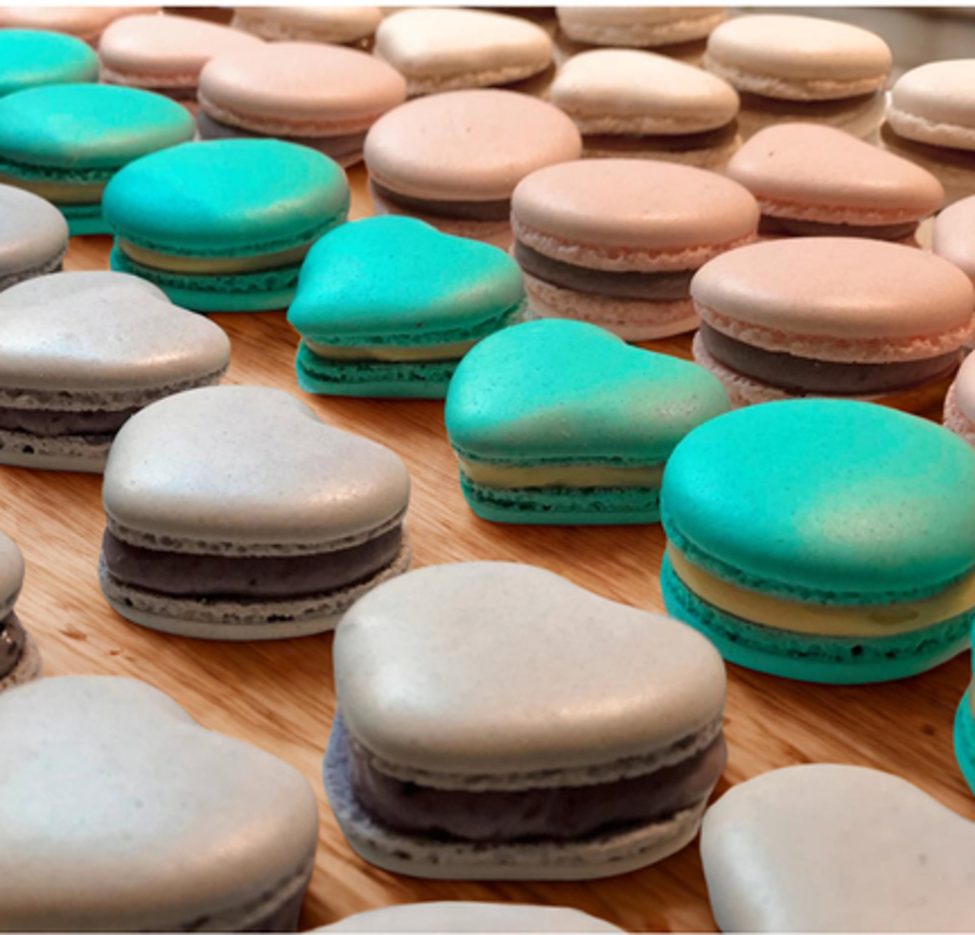 Colorful macarons filled with creamy ganache, showcasing a variety of vibrant flavors.