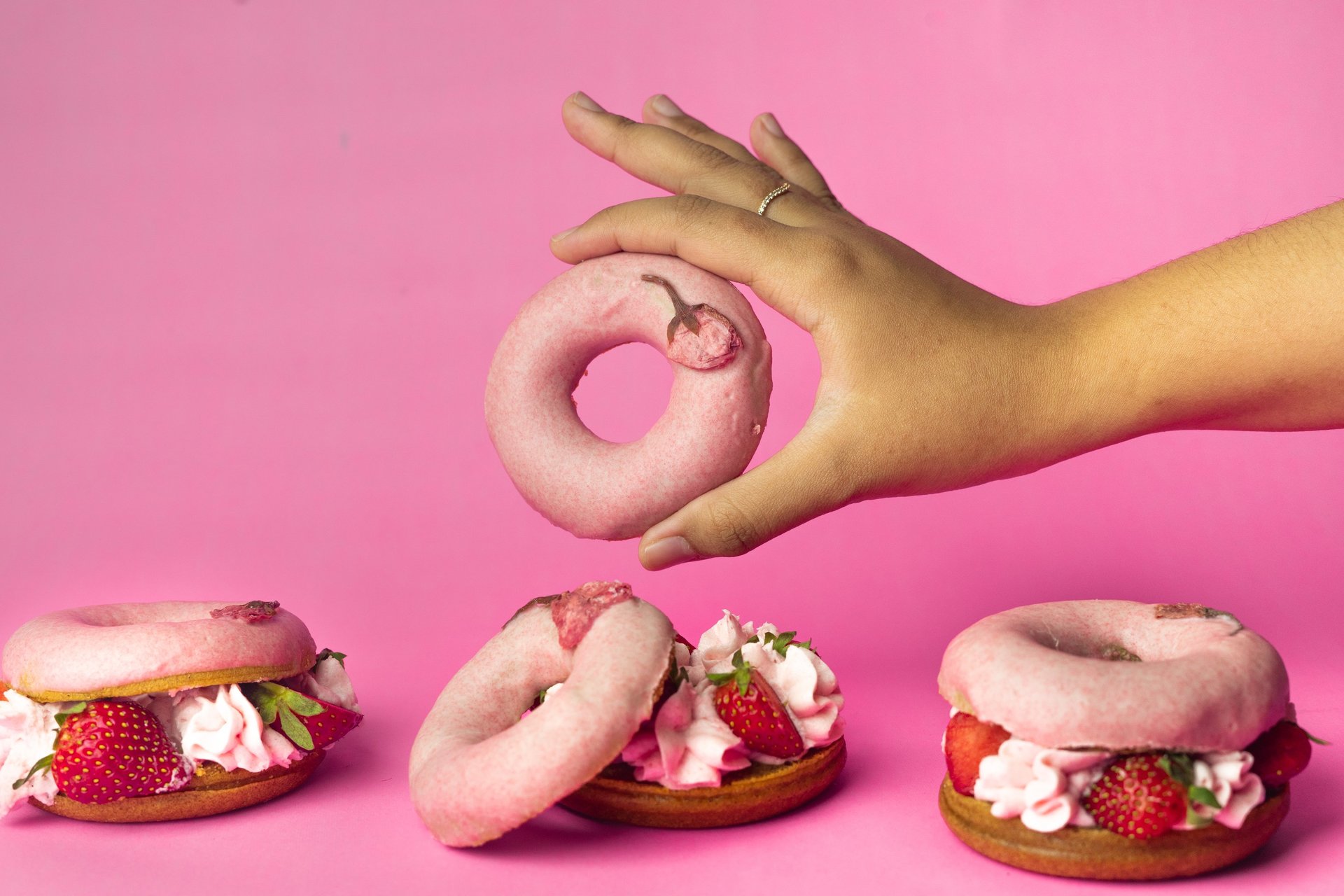 two strawberry doughnuts with sprinkles
