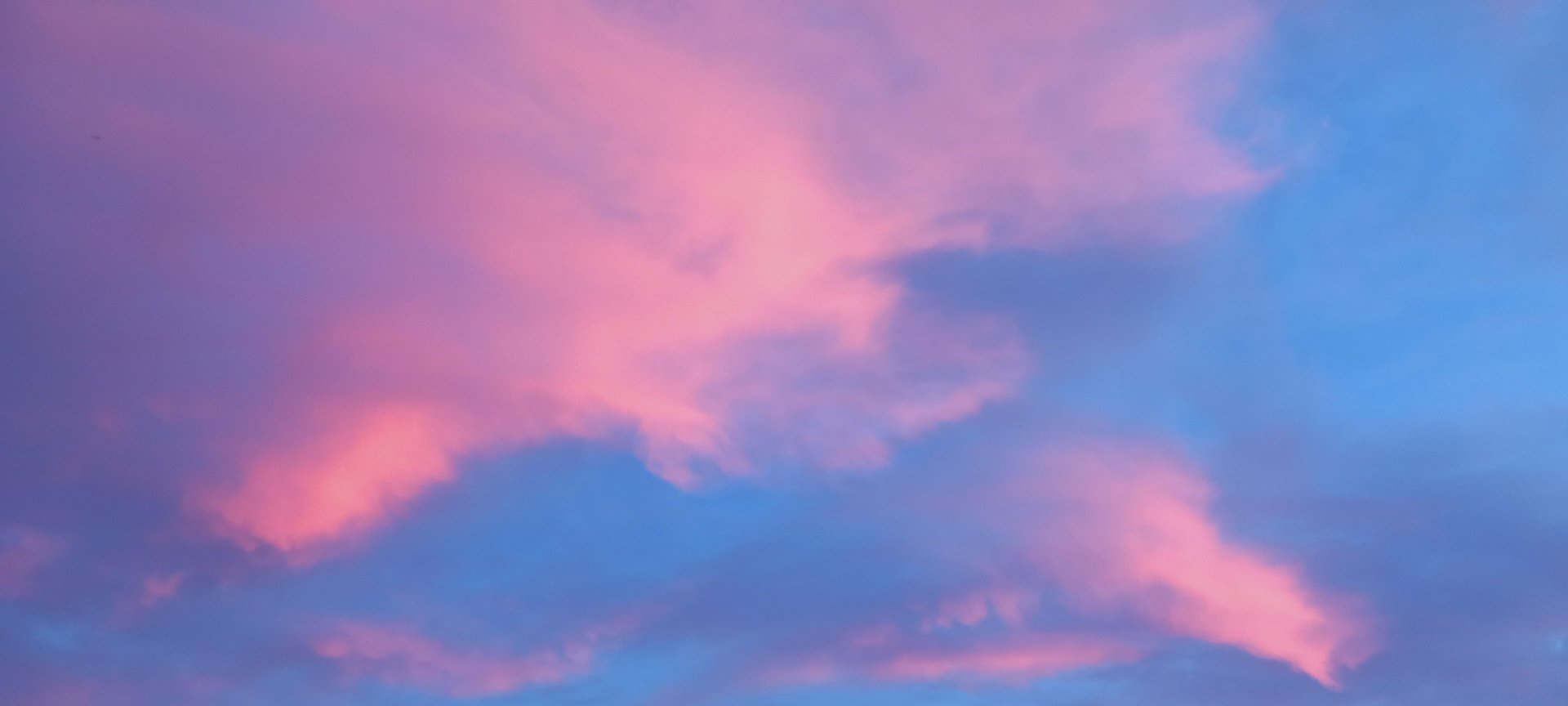 woman wearing yellow long-sleeved dress under white clouds and blue sky during daytime