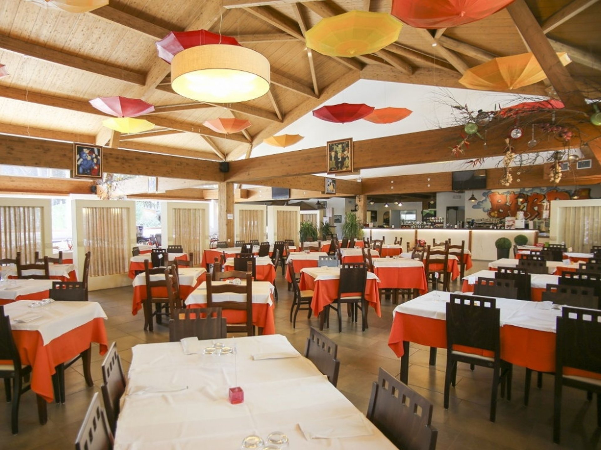 a table with a bowl of pasta and a basket of bread