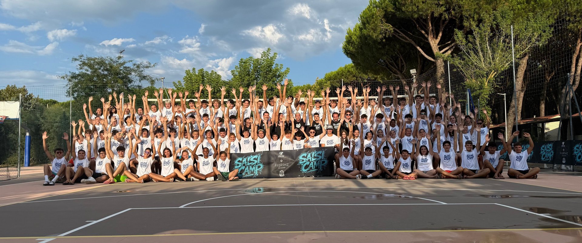 black metal fence on brown sand during sunset