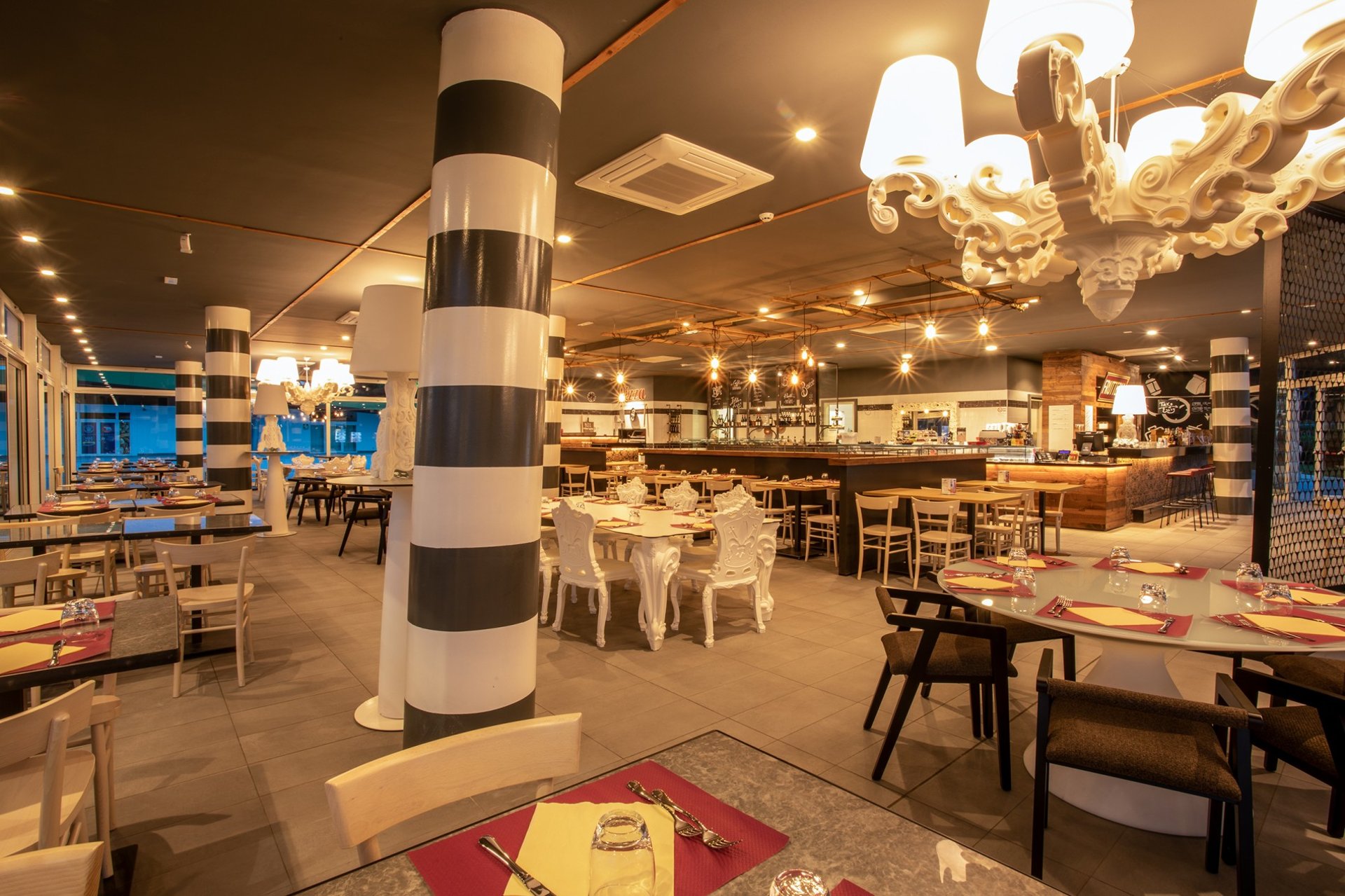 a table with a bowl of pasta and a basket of bread