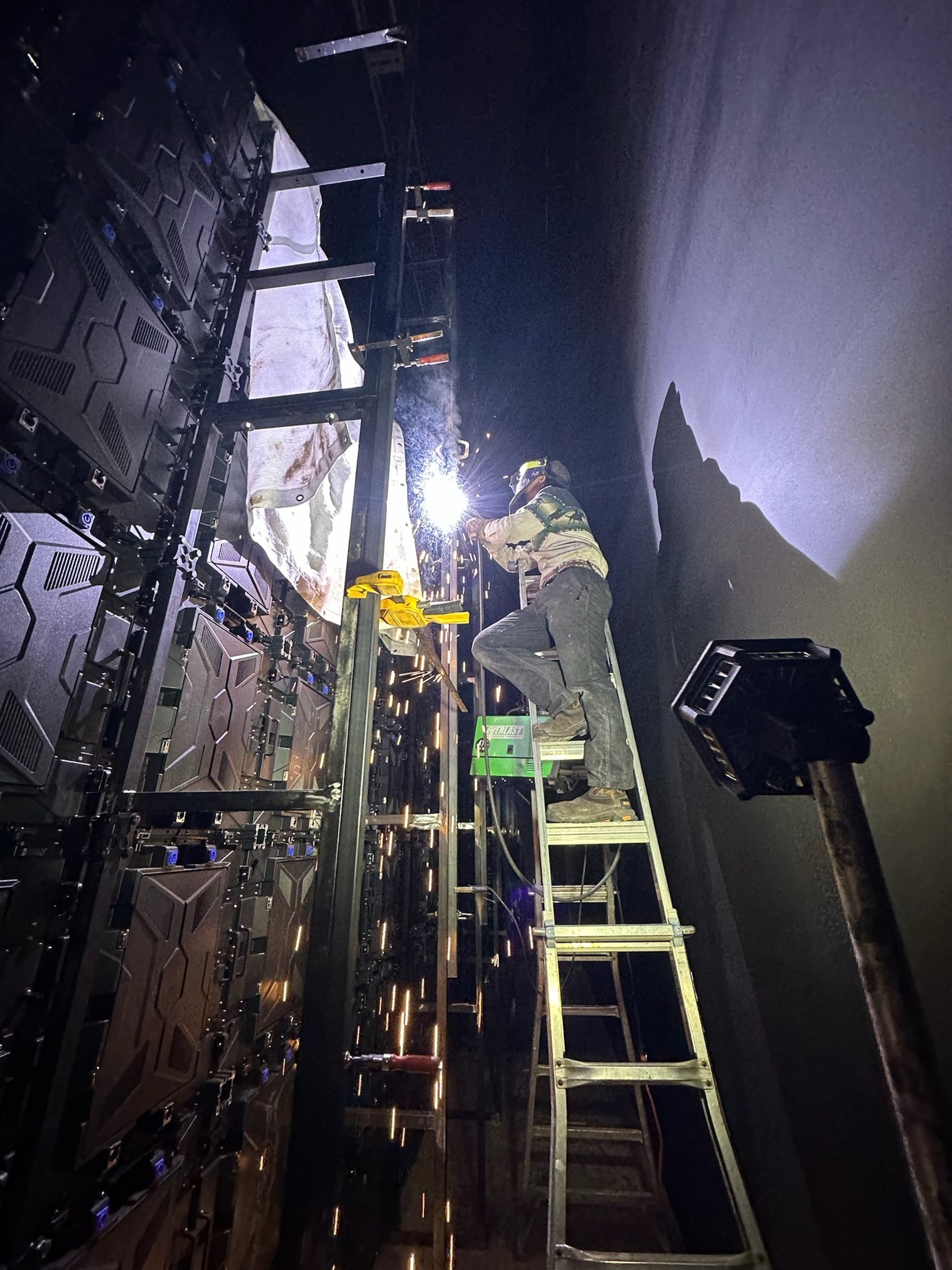 person welding metal using gray helmet