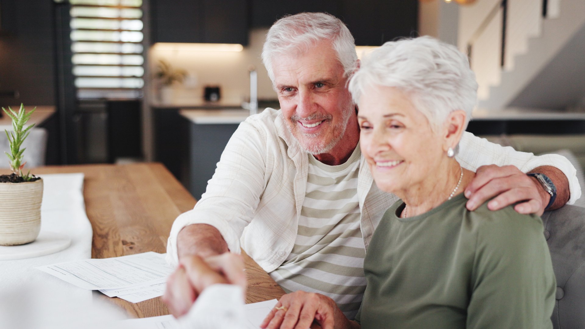 people holding shoulders sitting on wall