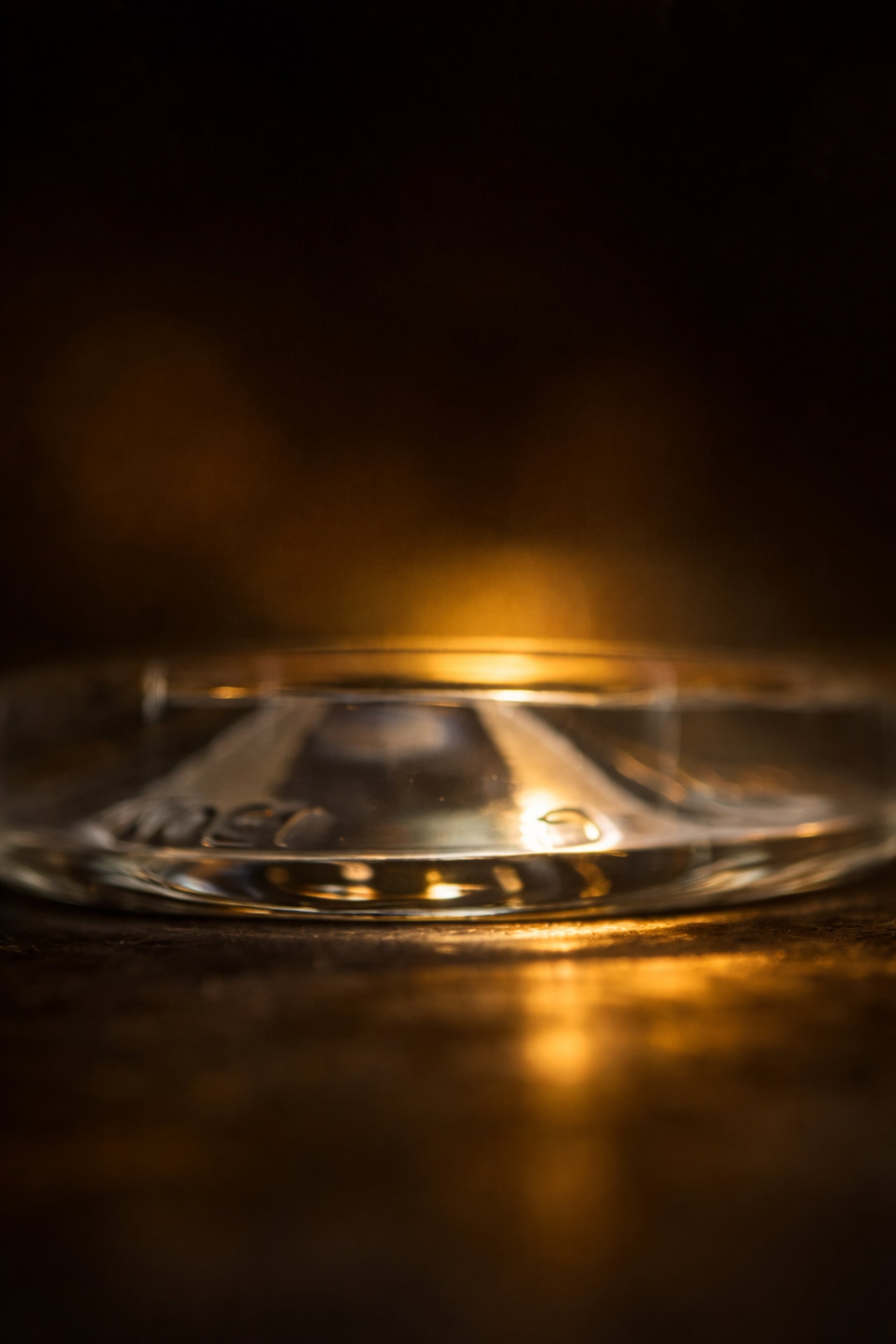 man in white dress shirt holding clear drinking glass