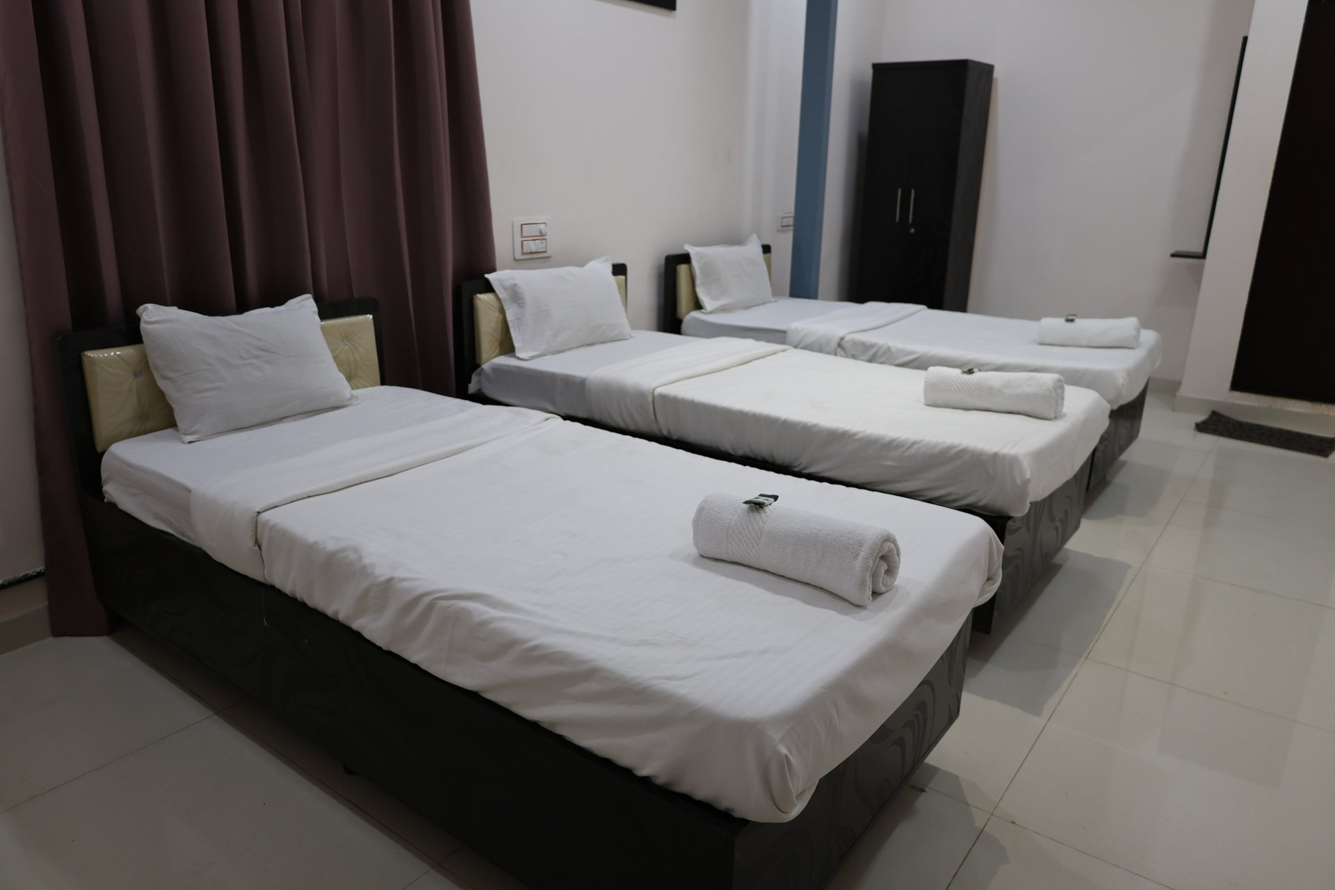 black and white bed near brown wooden table